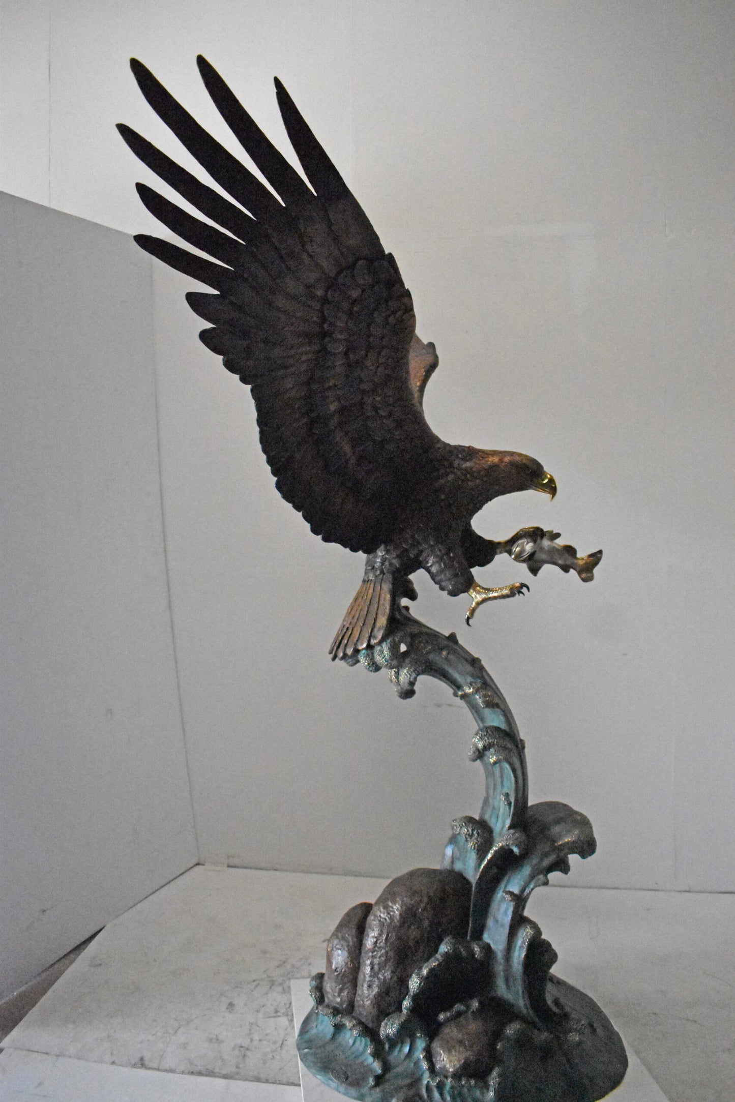 Eagle in Action Catching His Prey Bronze Statue - Size: 68"L x 40"W x 87"H.