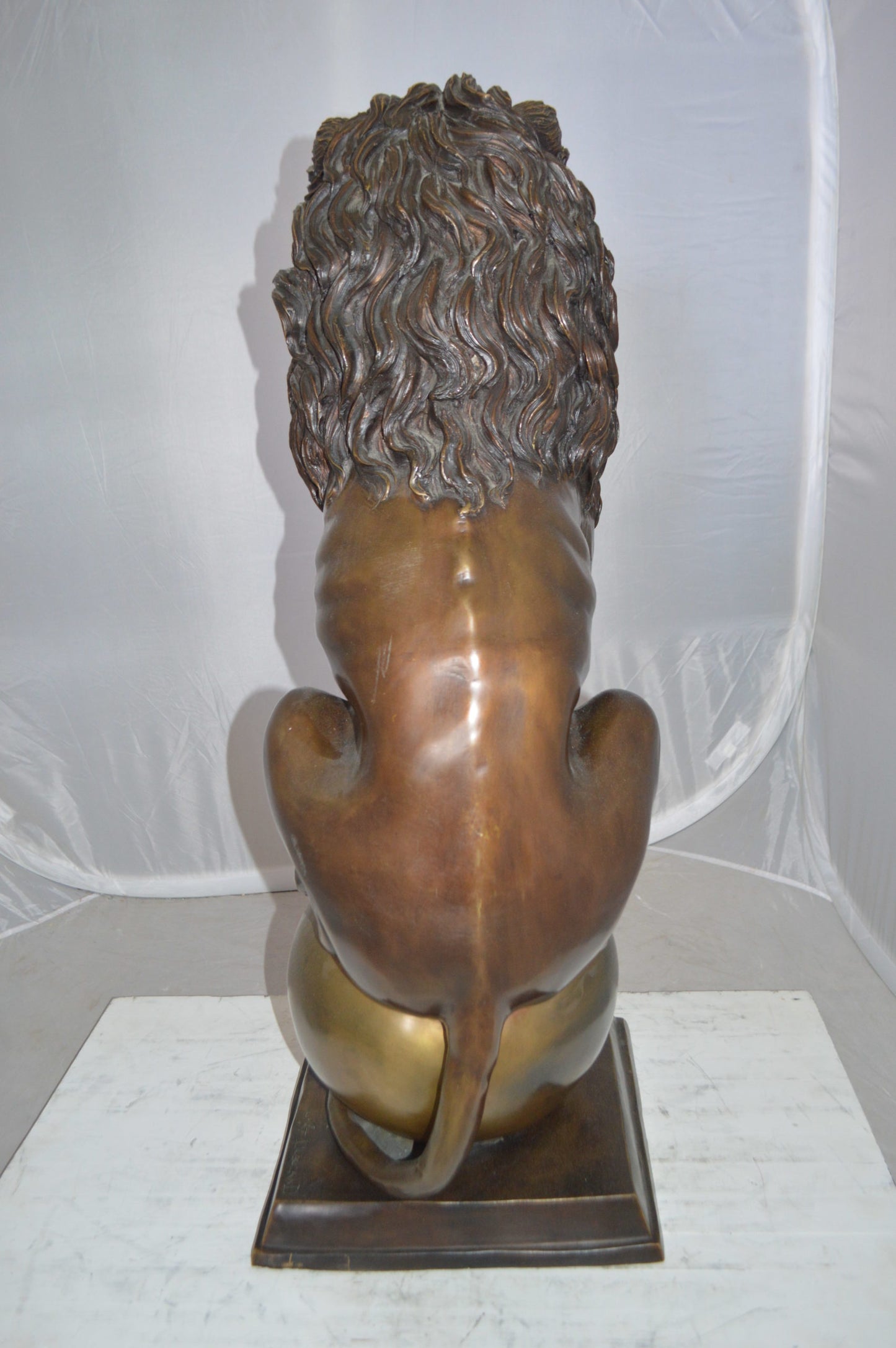 Pair of lions standing on balls, bronze statues - Size: 14"L x 16"W x 38"H.