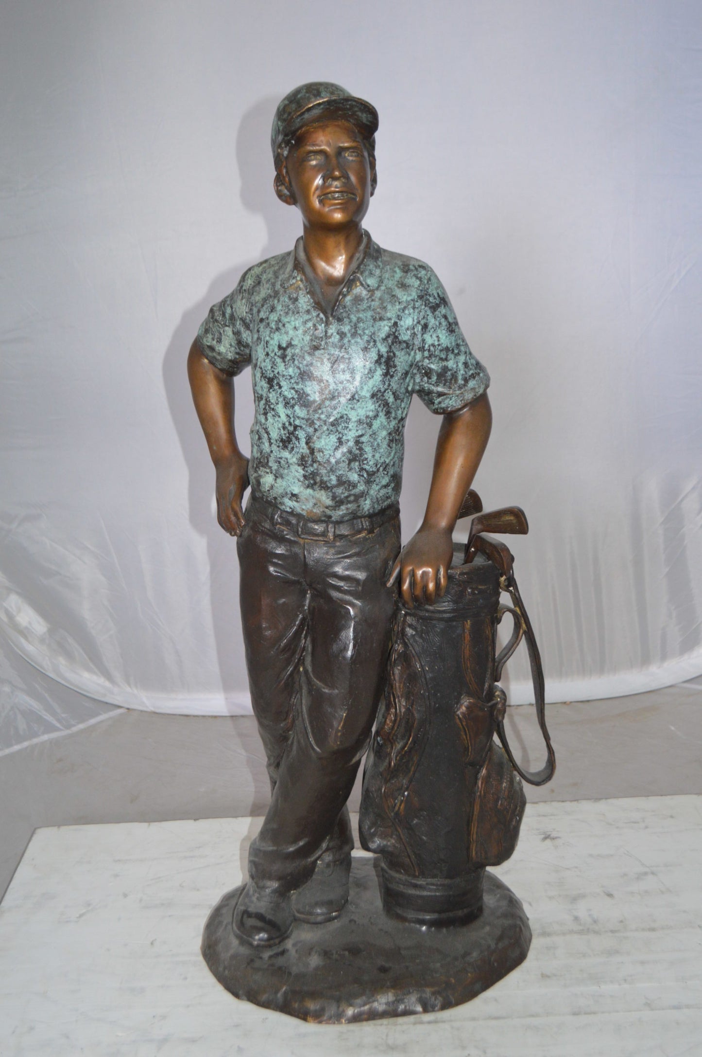 Golfer with bag Bronze Statue - Size: 12"L x 13"W x 32"H.