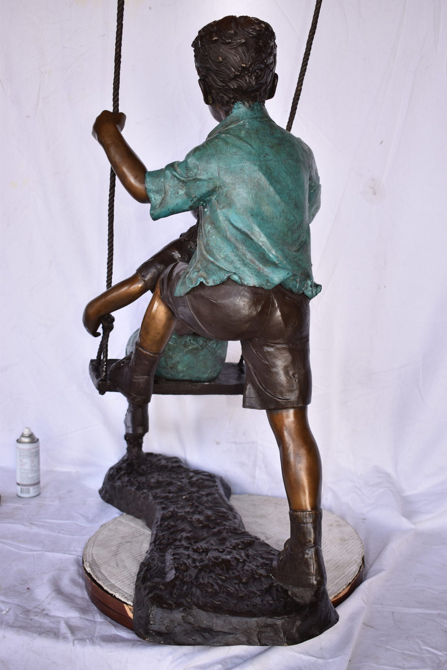 Boy and Girl Playing on a Swing bronze Statue - Size: 39"L x 17"W x 53"H.