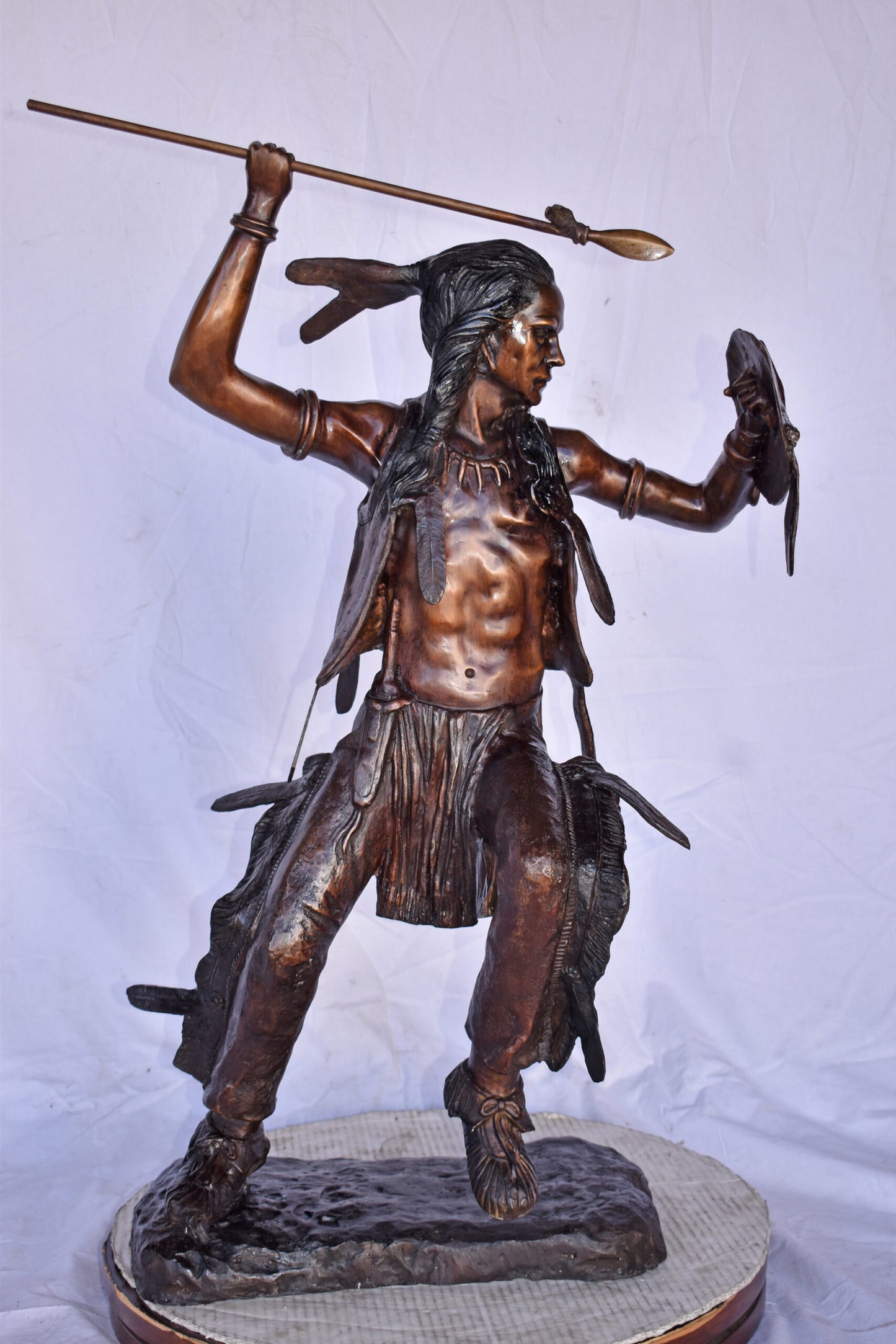 Indian Worrier Throwing a Spear Bronze Statue - Size: 15"L x 23"W x 38"H.