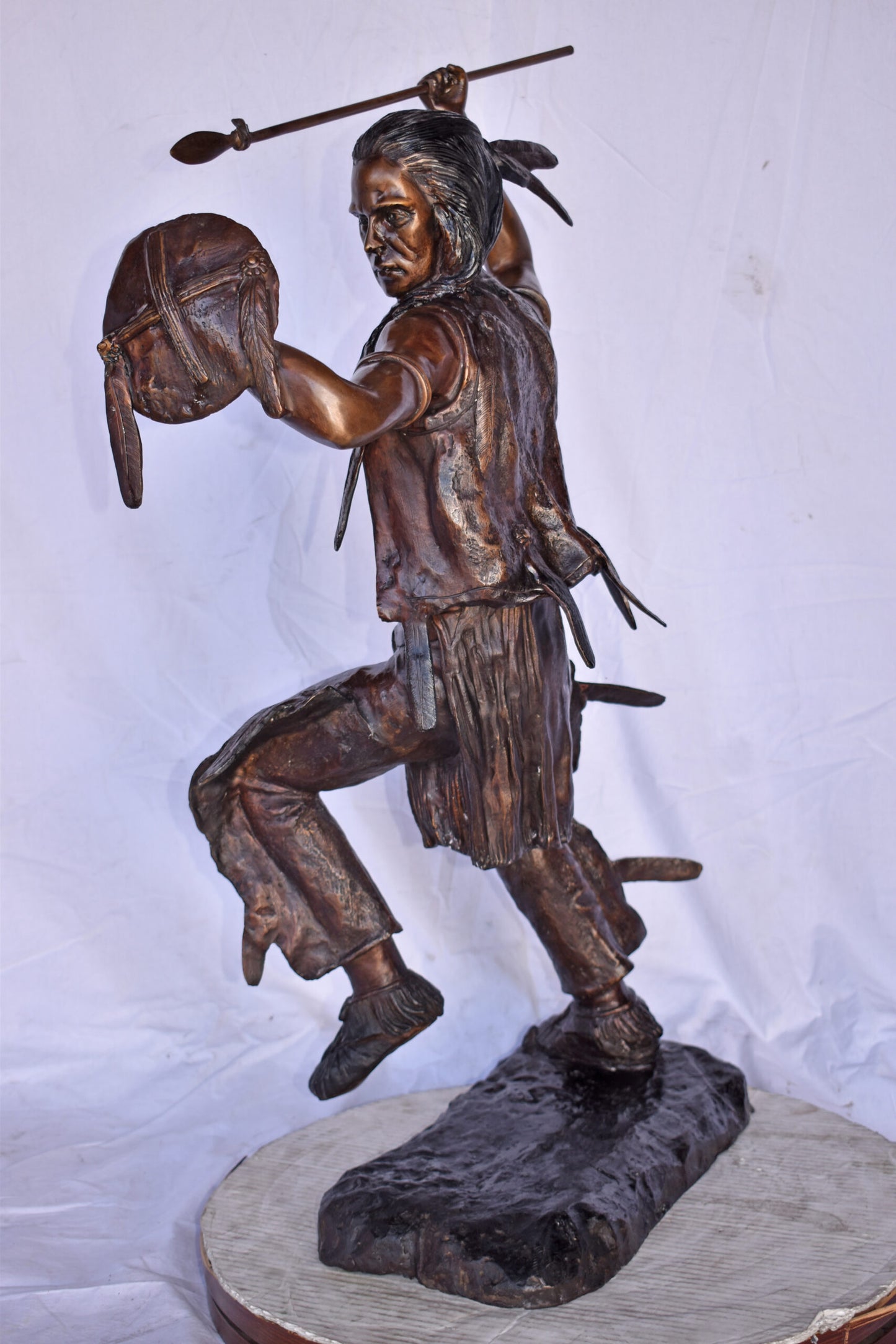 Indian Worrier Throwing a Spear Bronze Statue - Size: 15"L x 23"W x 38"H.