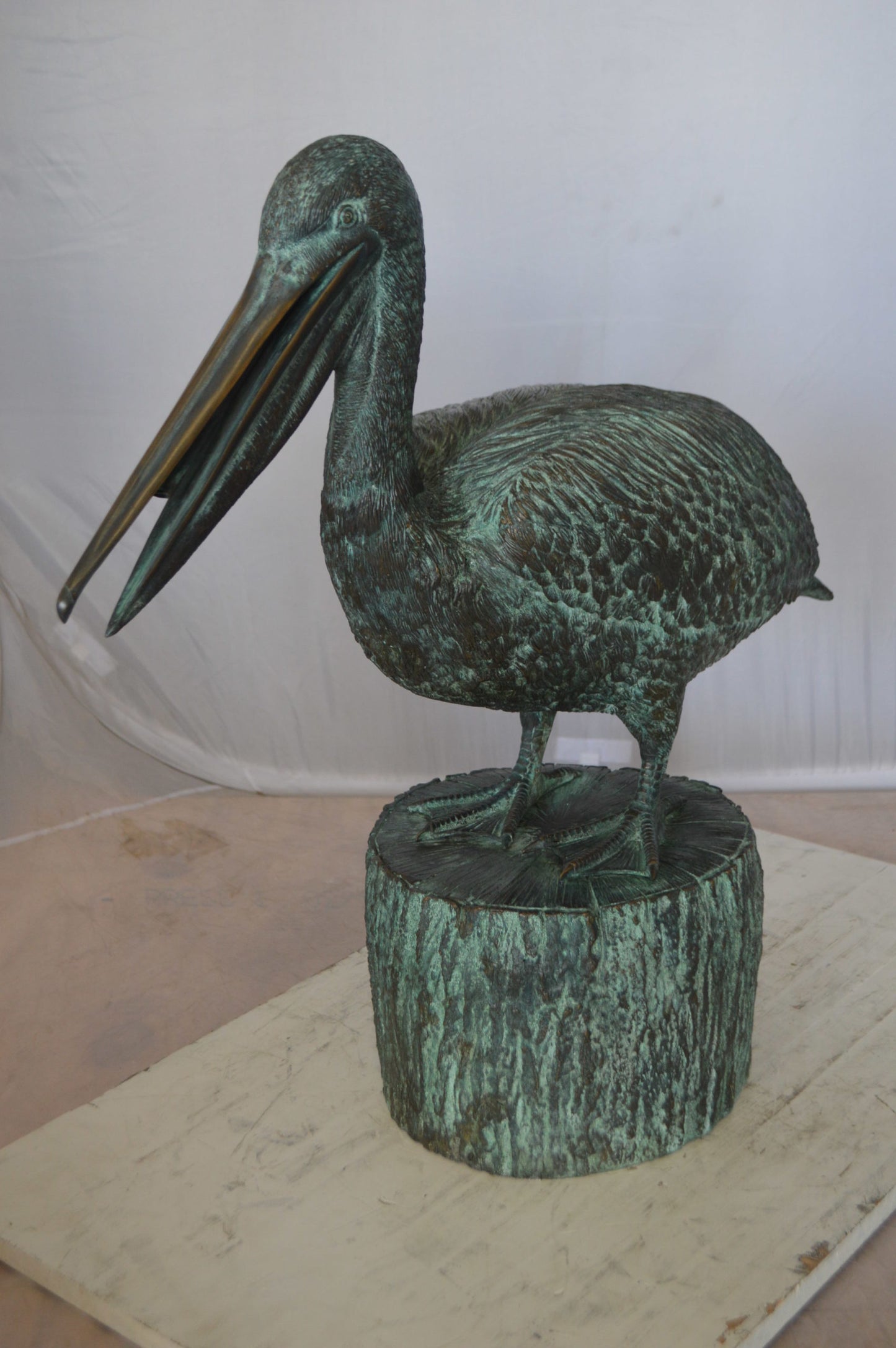 Pelican on a Tree Stump fountain bronze statue - Size: 30"L x 16"W x 46"H.