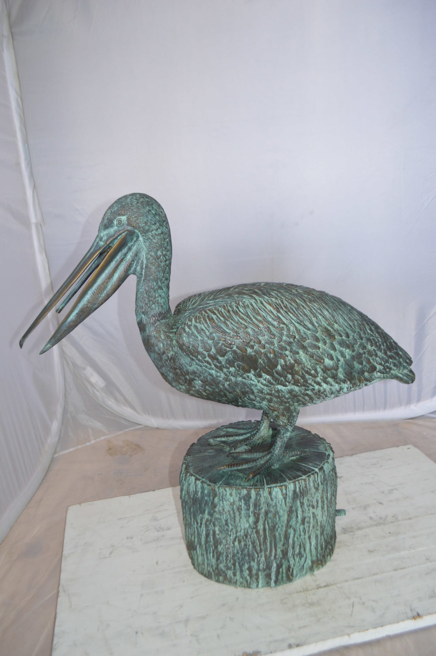 Pelican on a Tree Stump fountain bronze statue - Size: 30"L x 16"W x 46"H.