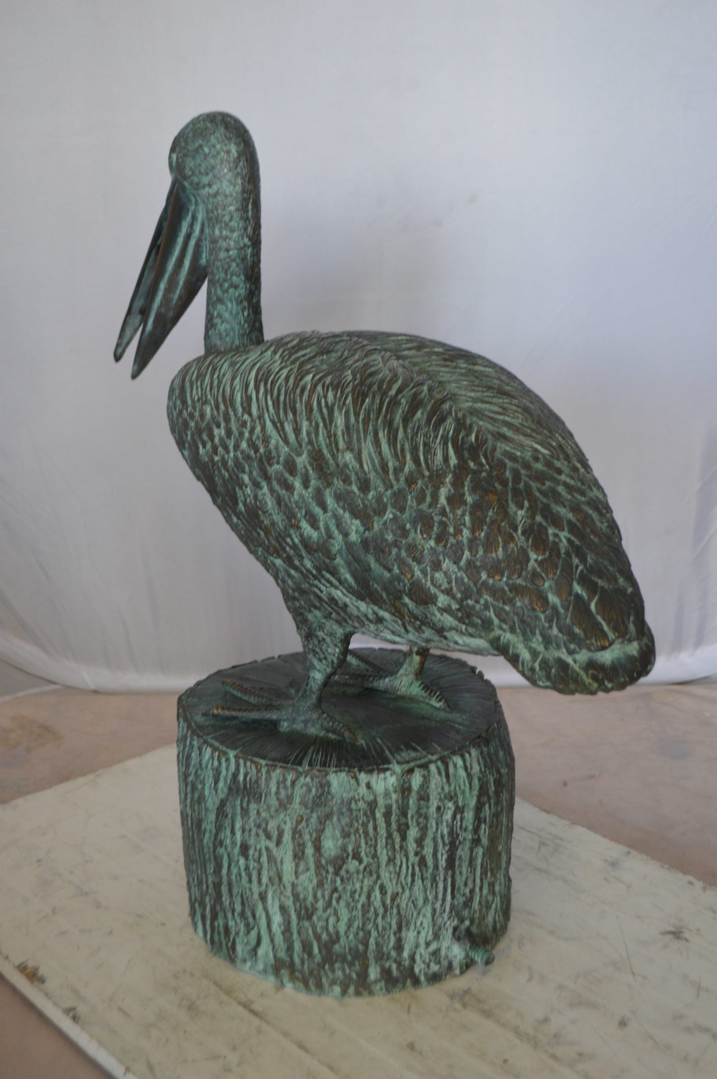 Pelican on a Tree Stump fountain bronze statue - Size: 30"L x 16"W x 46"H.