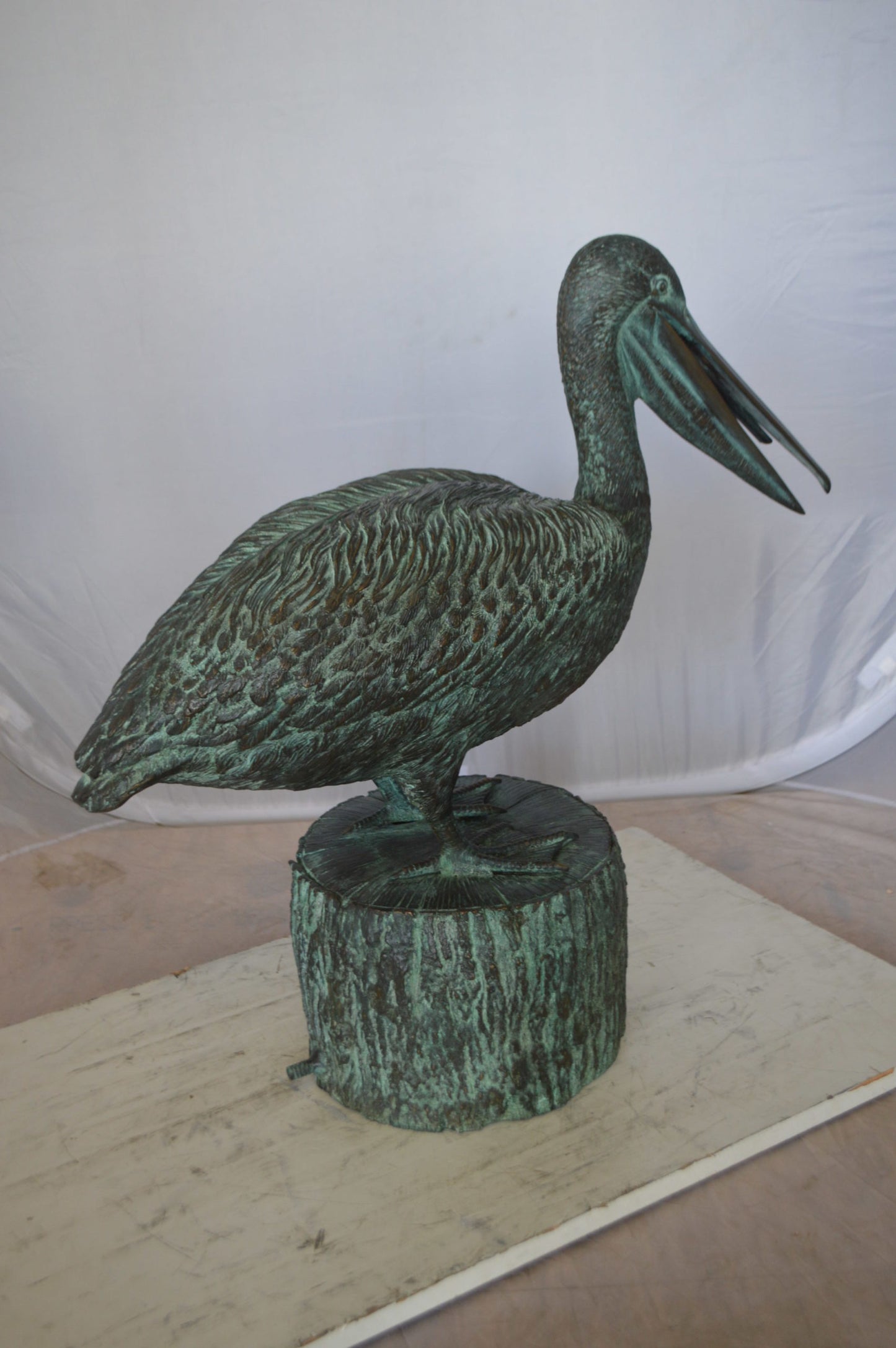 Pelican on a Tree Stump fountain bronze statue - Size: 30"L x 16"W x 46"H.