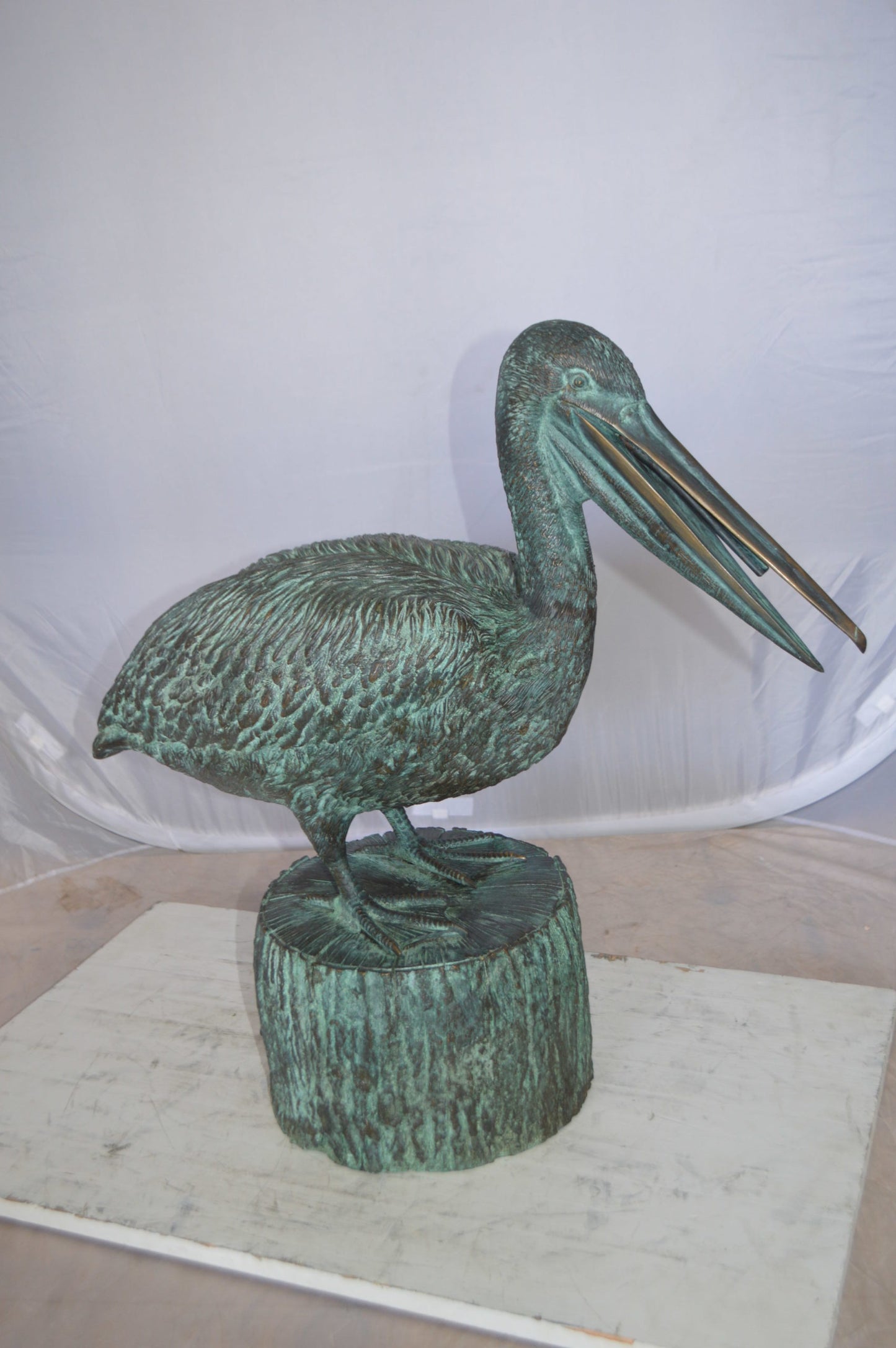 Pelican on a Tree Stump fountain bronze statue - Size: 30"L x 16"W x 46"H.