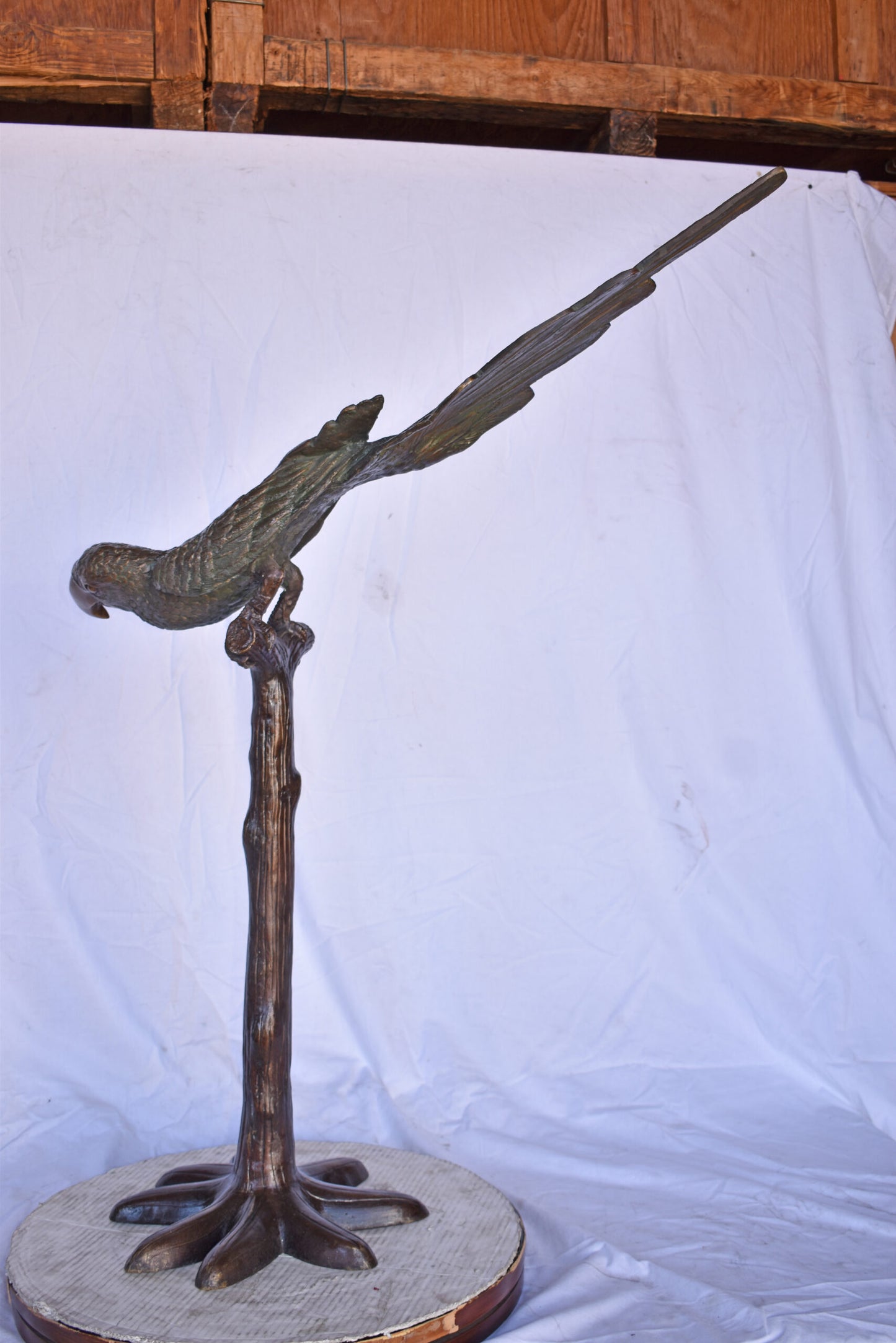 Parrot on a Tree looking Down Bronze Statue - Size: 37"L x 15"W x 47"H.