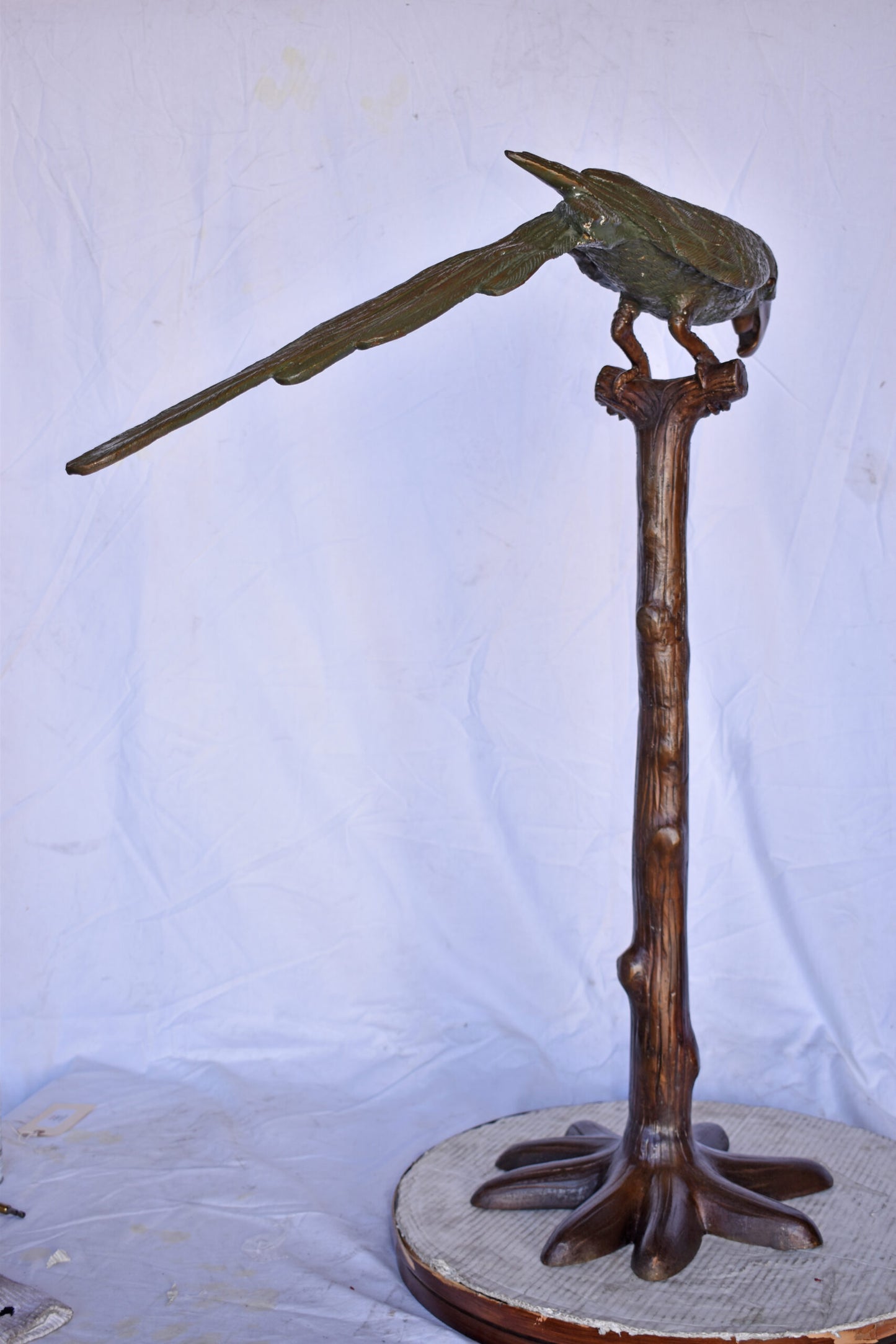 Parrot on a Tree Watching Forward Bronze Statue - Size: 36"L x 15"W x 41"H.