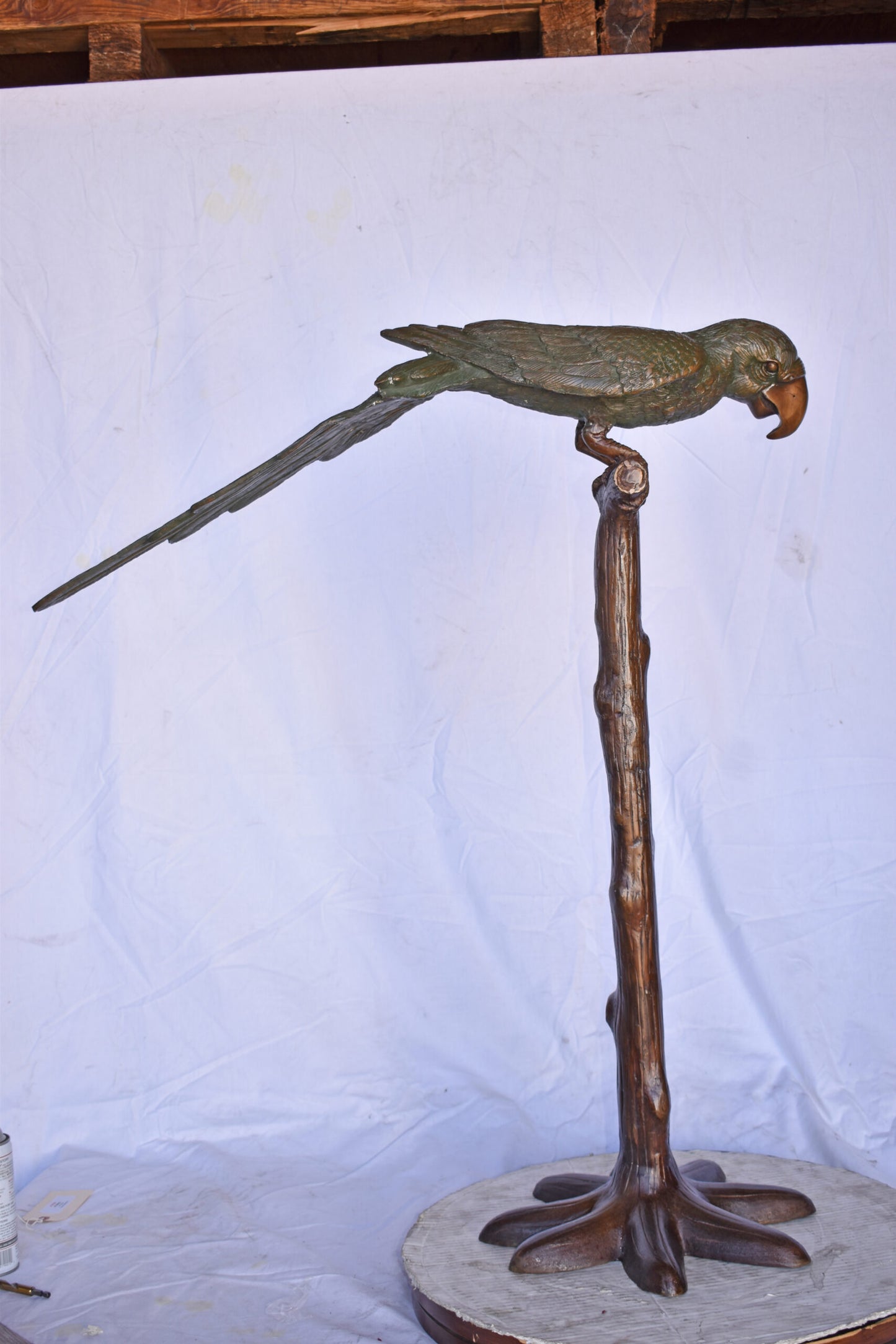 Parrot on a Tree Watching Forward Bronze Statue - Size: 36"L x 15"W x 41"H.