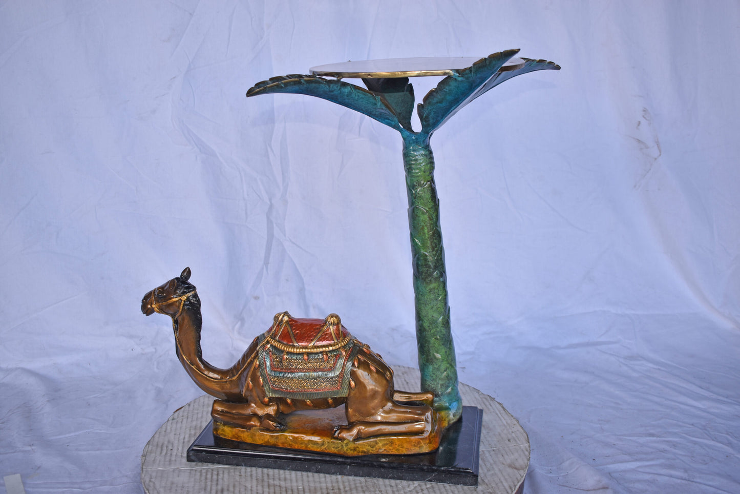 Camel Sitting Under A Palm Tree Bronze Statue - Size: 17"L x 27"W x 23"H.