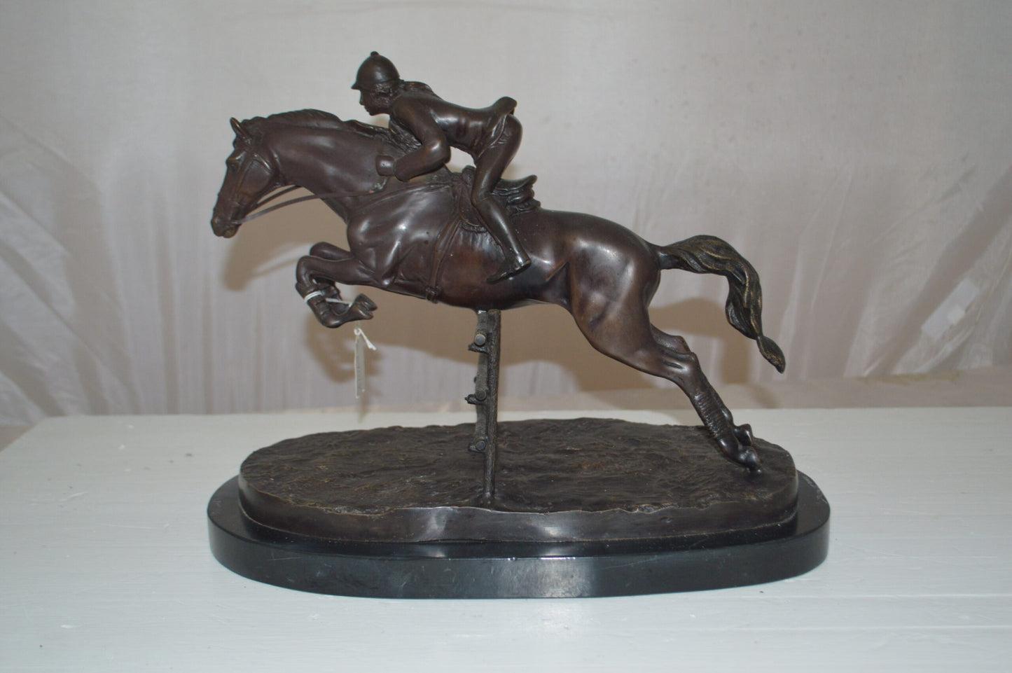Jockey With Horse Jumping Over Hurdle Bronze Statue - Size: 14"L x 9"W x 13"H.