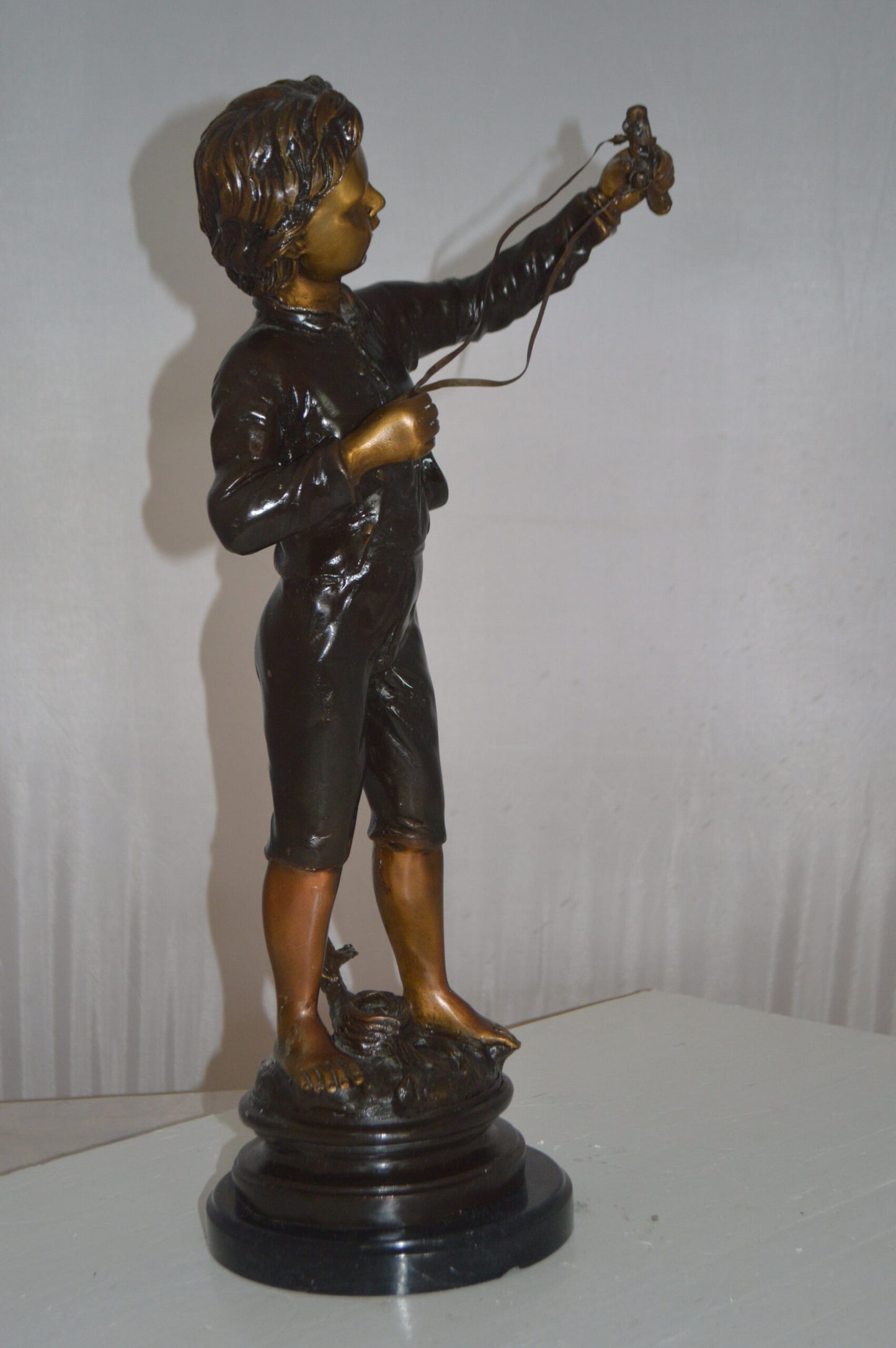 Boy with a Slingshot Bronze Statue -  Size: 12"L x 7"W x 21"H.