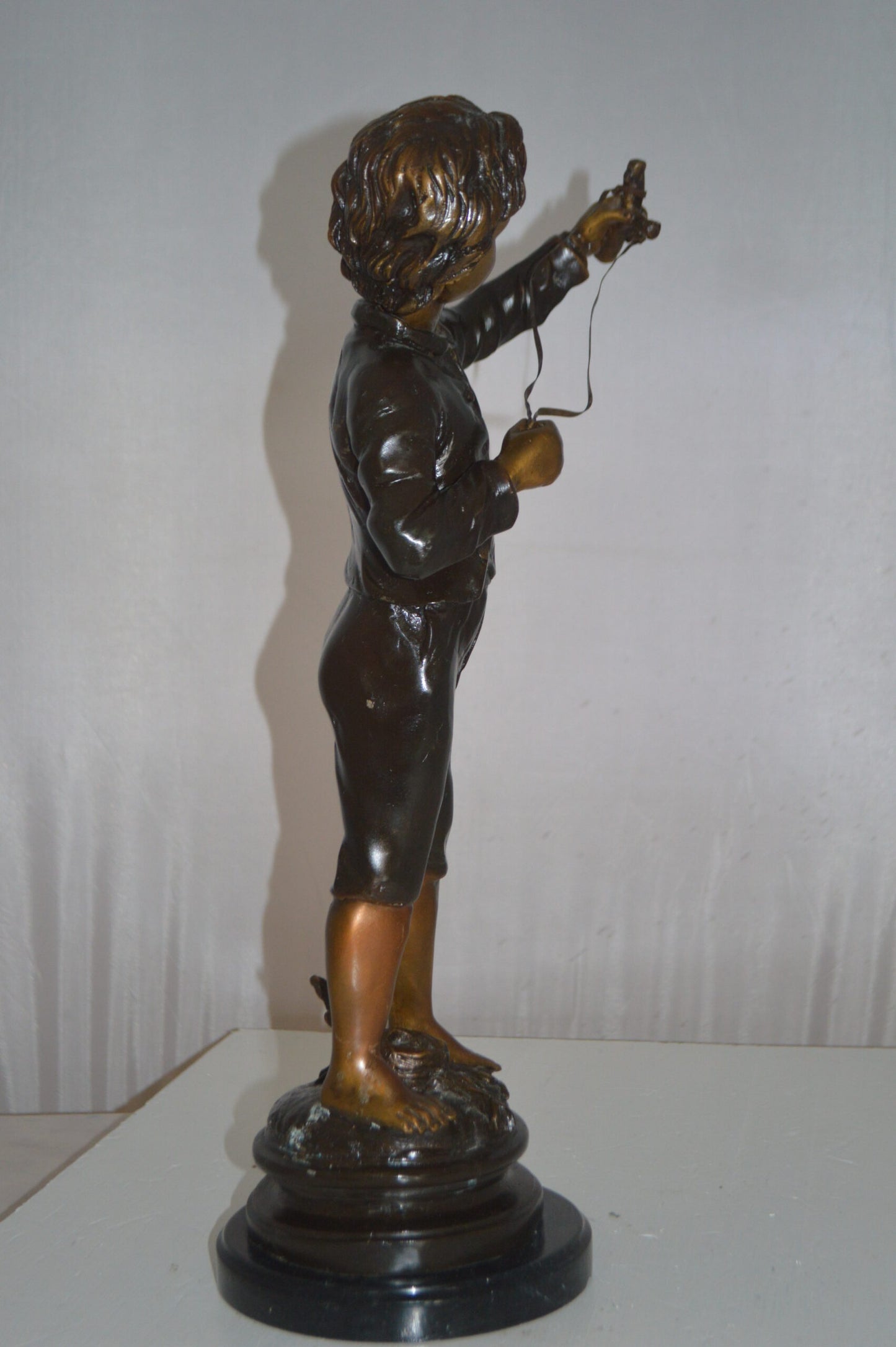 Boy with a Slingshot Bronze Statue -  Size: 12"L x 7"W x 21"H.