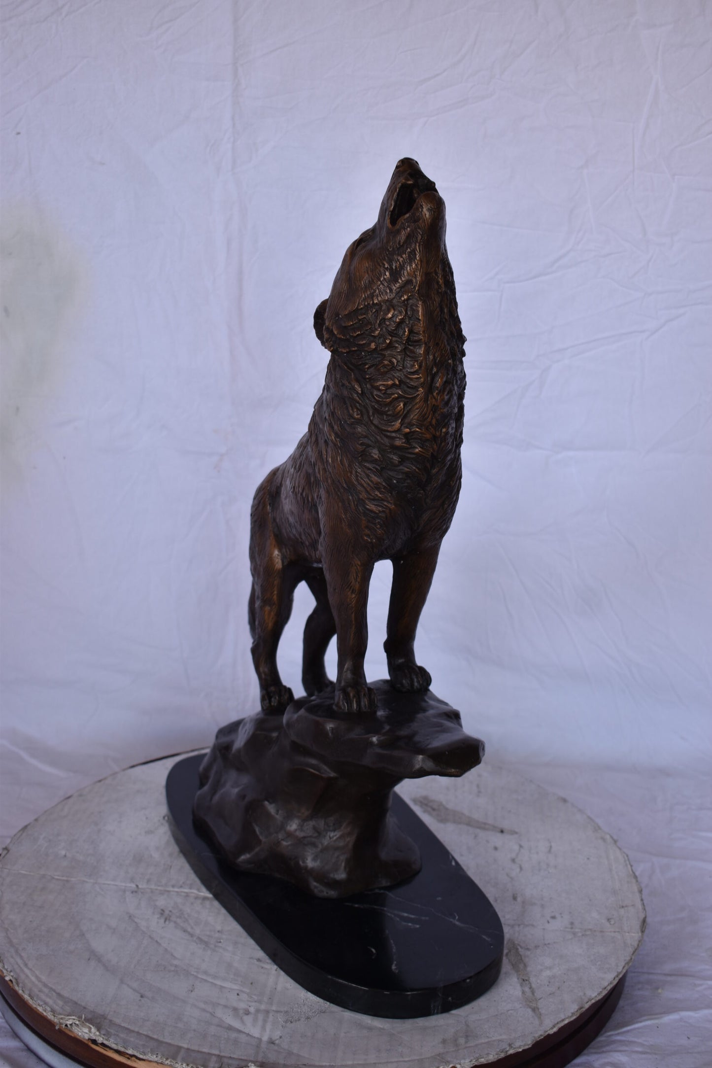 Howling Wolf at Edge of a Cliff Bronze Statue - Size: 9"L x 20"W x 26"H.