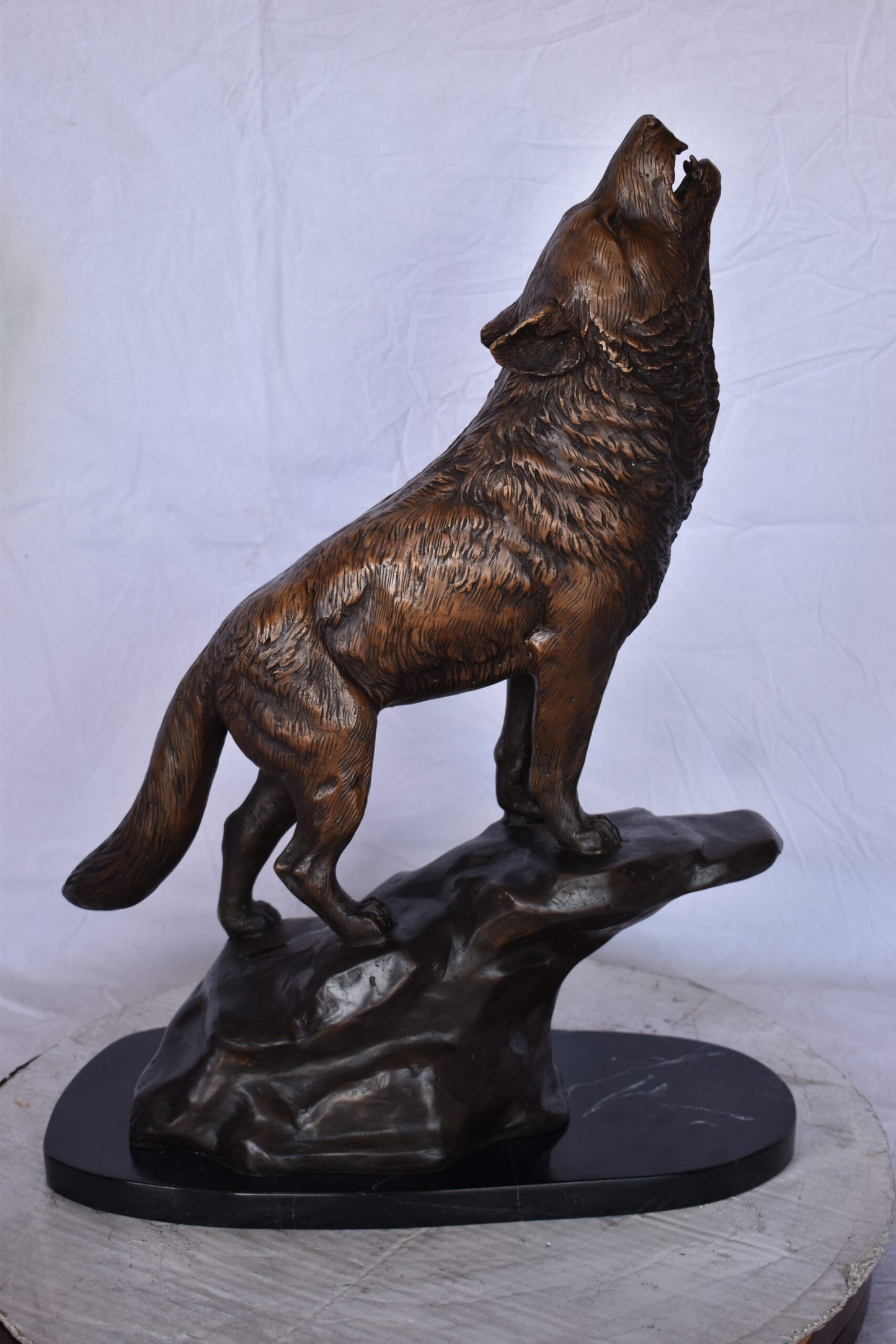 Howling Wolf at Edge of a Cliff Bronze Statue - Size: 9"L x 20"W x 26"H.