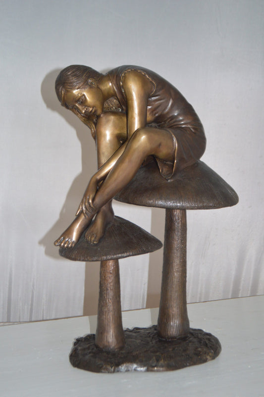 Girl sitting on Mushrooms Bronze Statue - Size: 13"L x 11"W x 18"H.