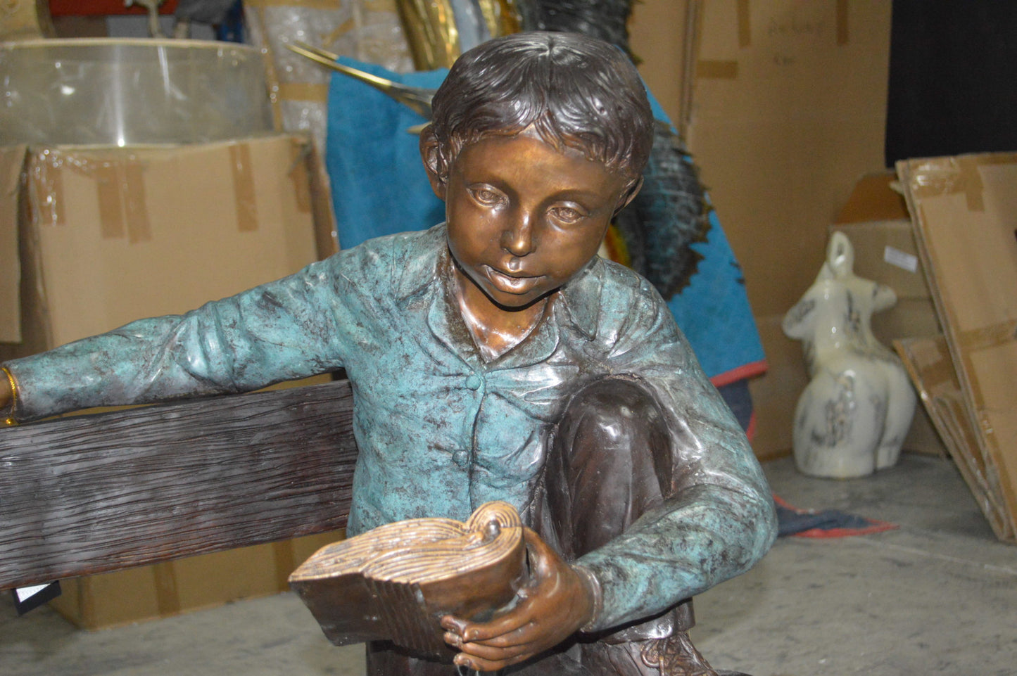 boy Sitting on a Bench reading book bronze Statue - Size: 43"L x 20"W x 36"H.