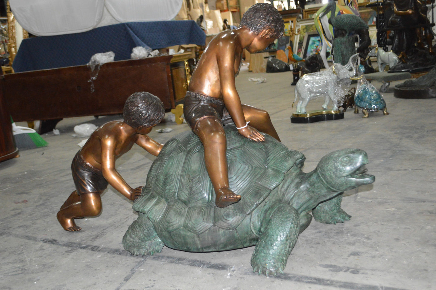 Two Kids on a Giant Turtle Bronze Fountain - Size: 23"L x 60"W x 33"H.