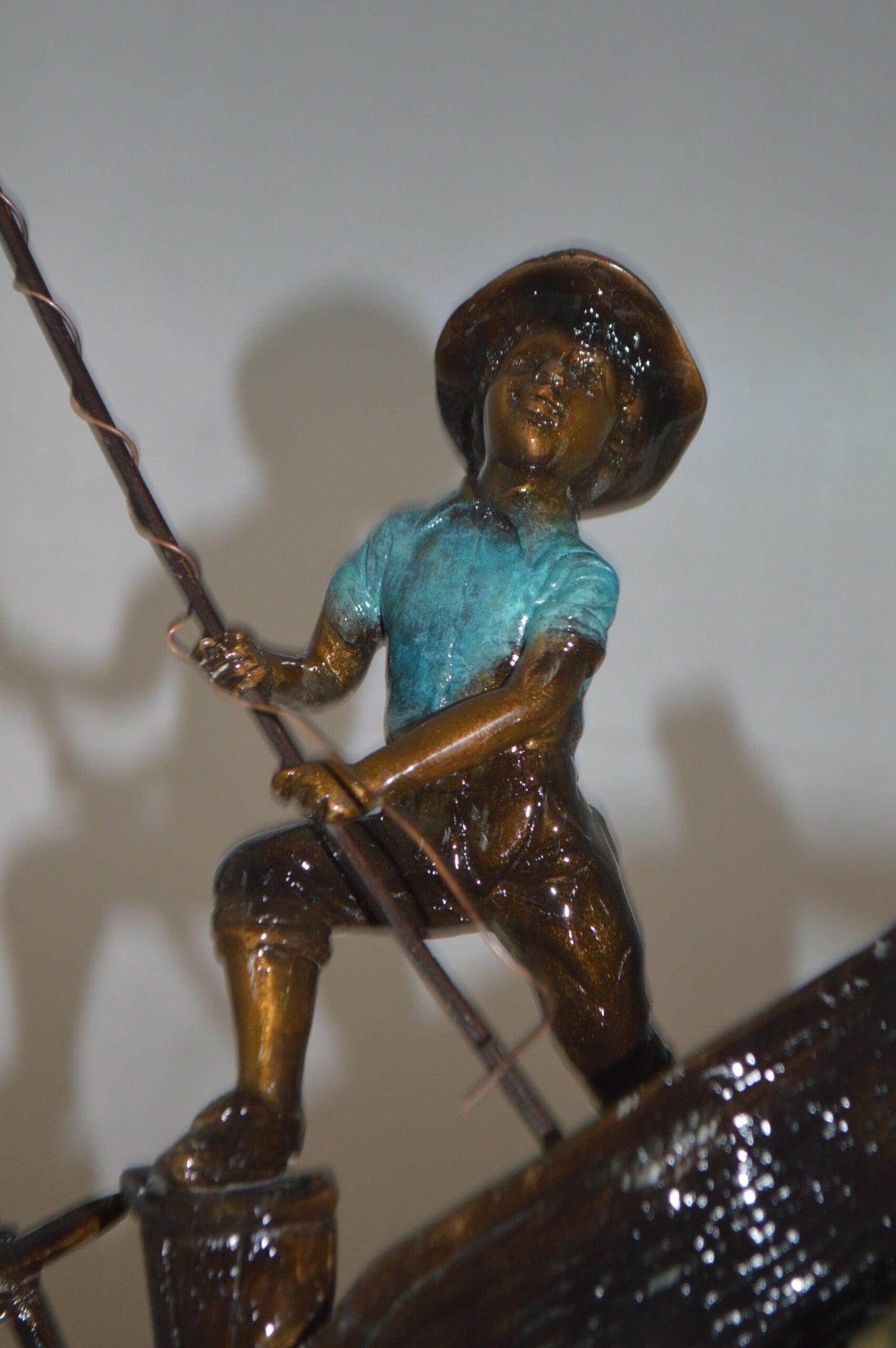 Old Man Fishing a Large Catch Bronze Statue - Size: 27"L x 13"W x 30"H.