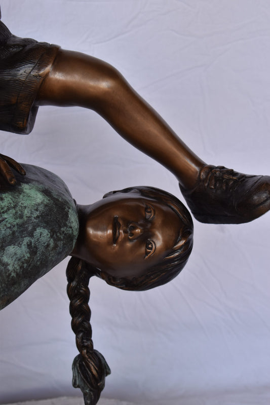 Two Girls Playing Leapfrog Jumping Bronze Statue - Size: 30"L x 14"W x 34"H.