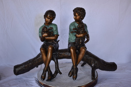 Boy and Girl with Pets Sitting on Log Bronze Statue - Size: 44"L x 22"W x 26"H.