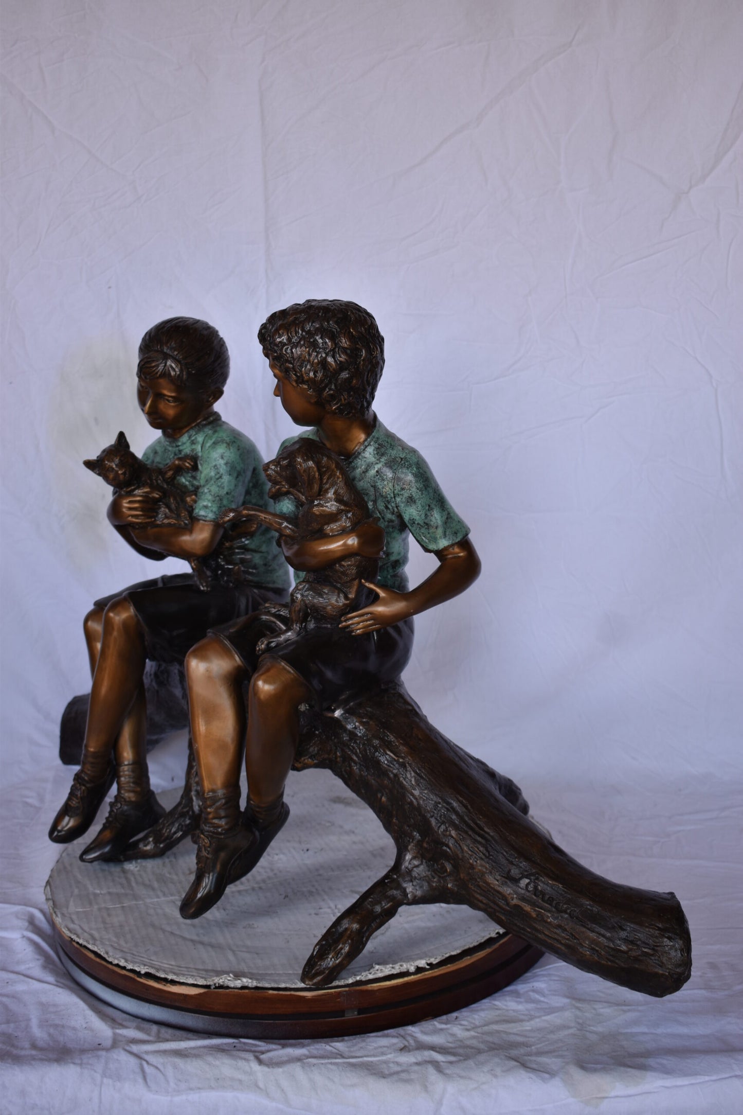 Boy and Girl with Pets Sitting on Log Bronze Statue - Size: 44"L x 22"W x 26"H.