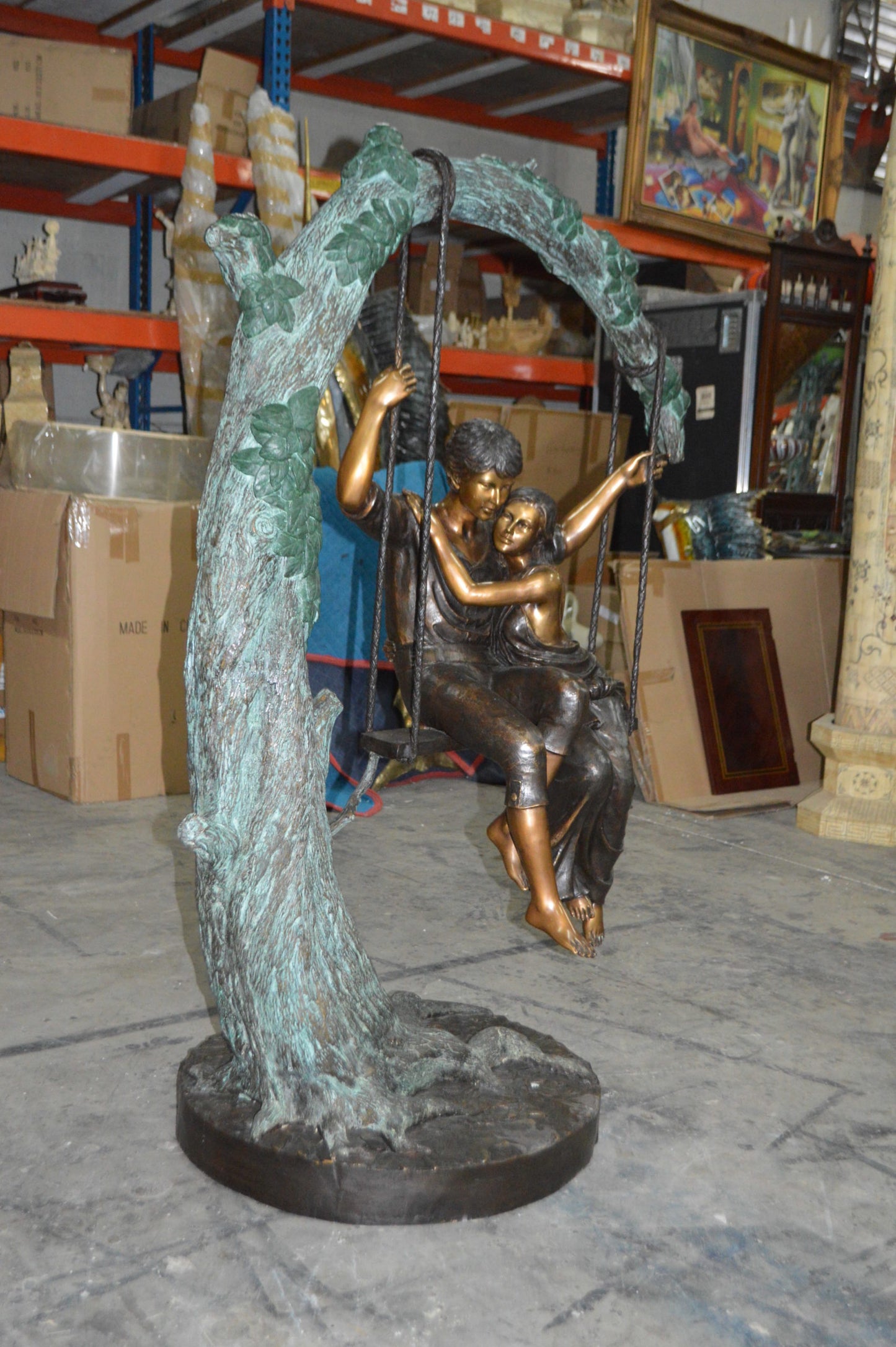 Lovers on a Swing Bronze Statue - Size: 48"L x 32"W x 64"H.