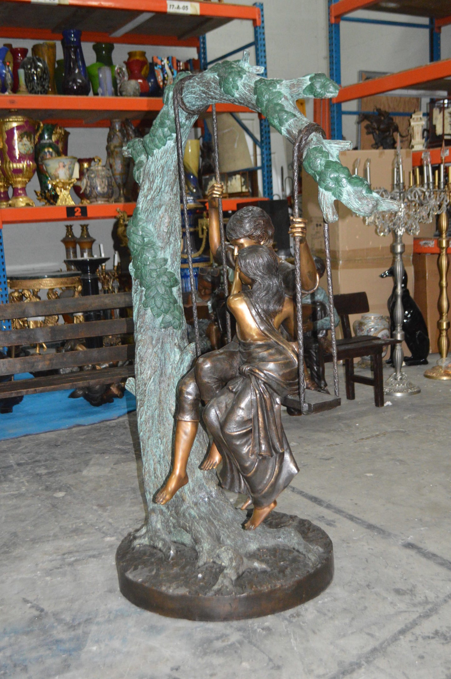 Lovers on a Swing Bronze Statue - Size: 48"L x 32"W x 64"H.