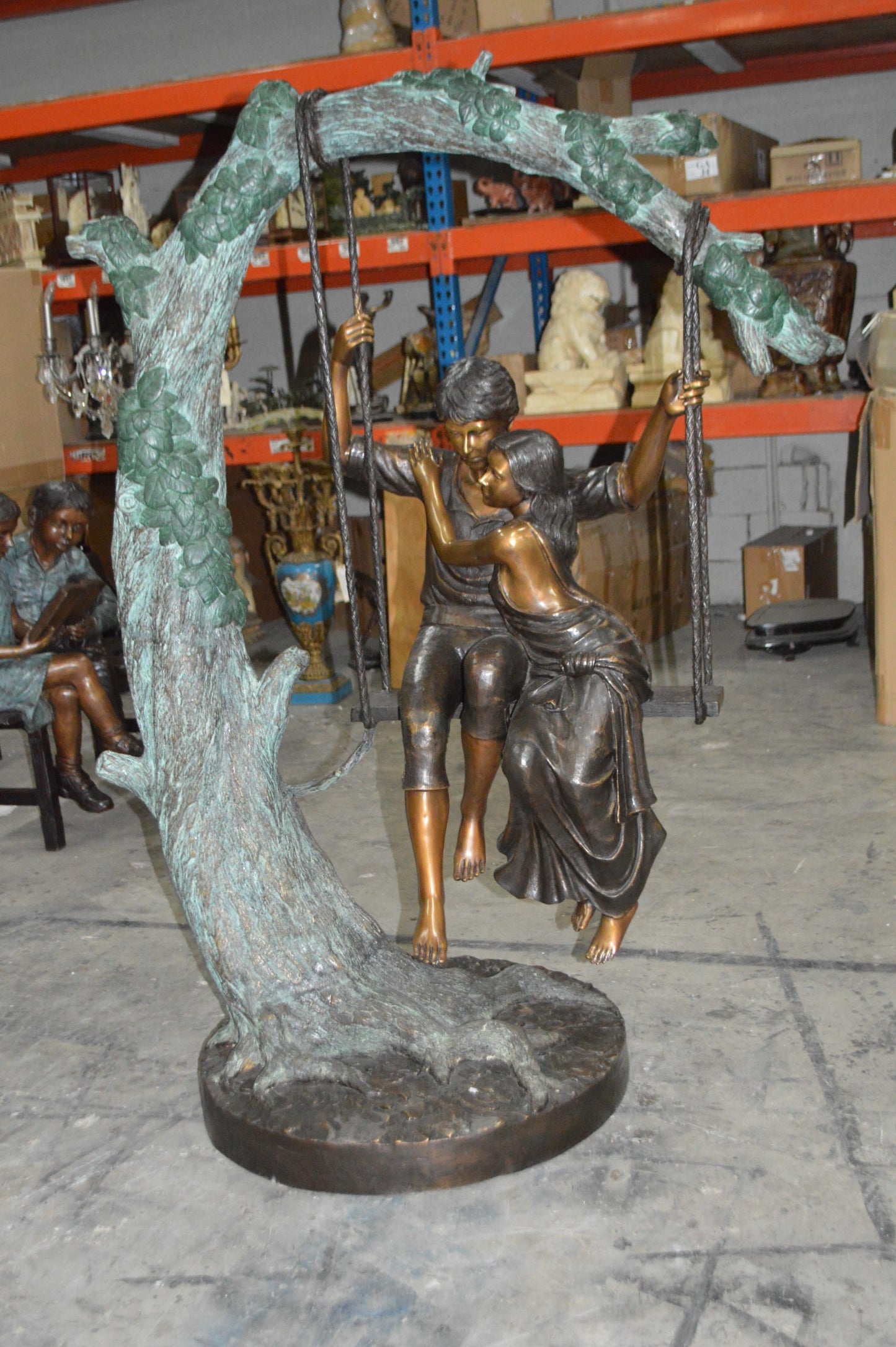 Lovers on a Swing Bronze Statue - Size: 48"L x 32"W x 64"H.