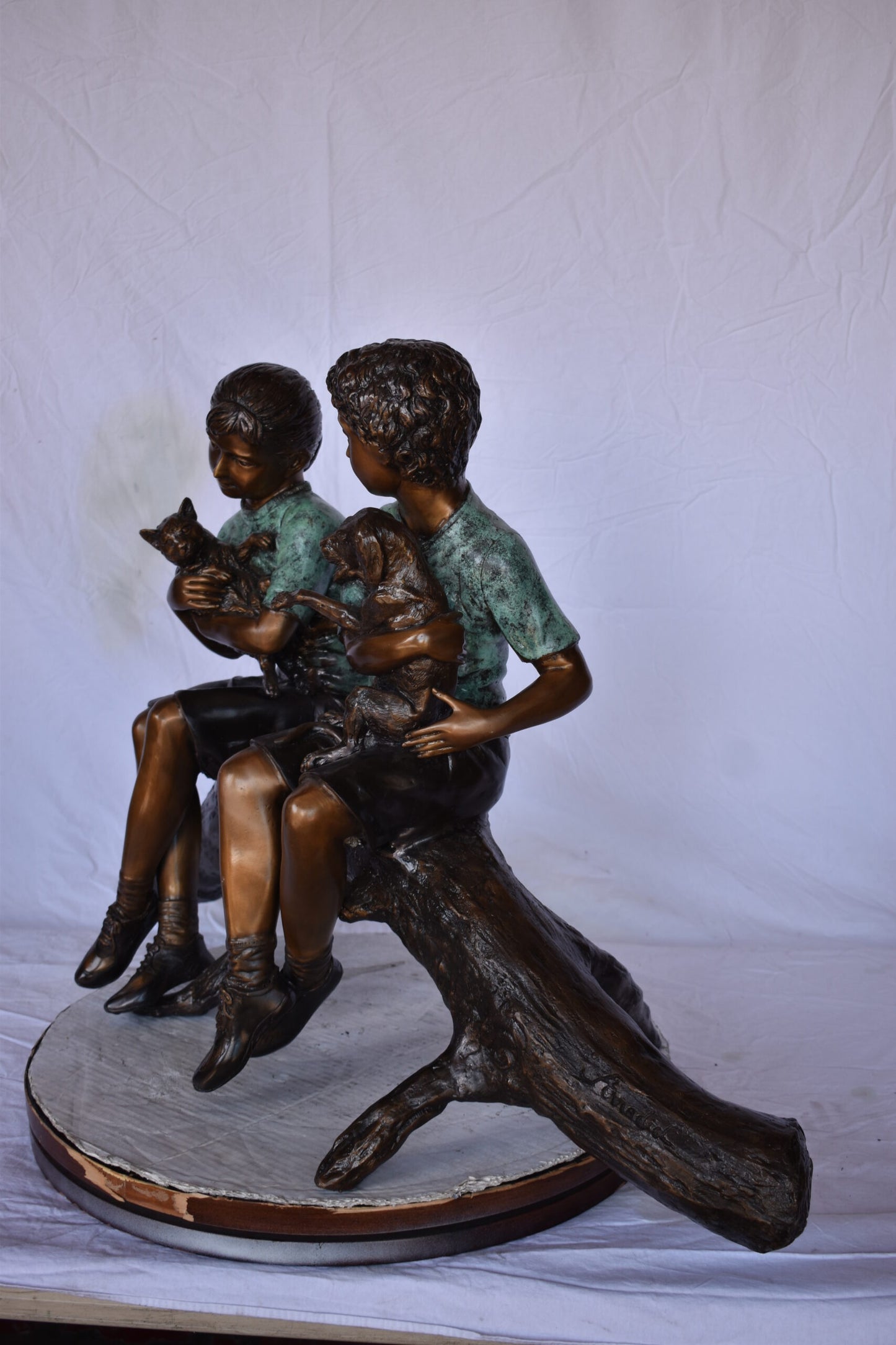 Boy and Girl with Pets Sitting on Log Bronze Statue - Size: 44"L x 22"W x 26"H.