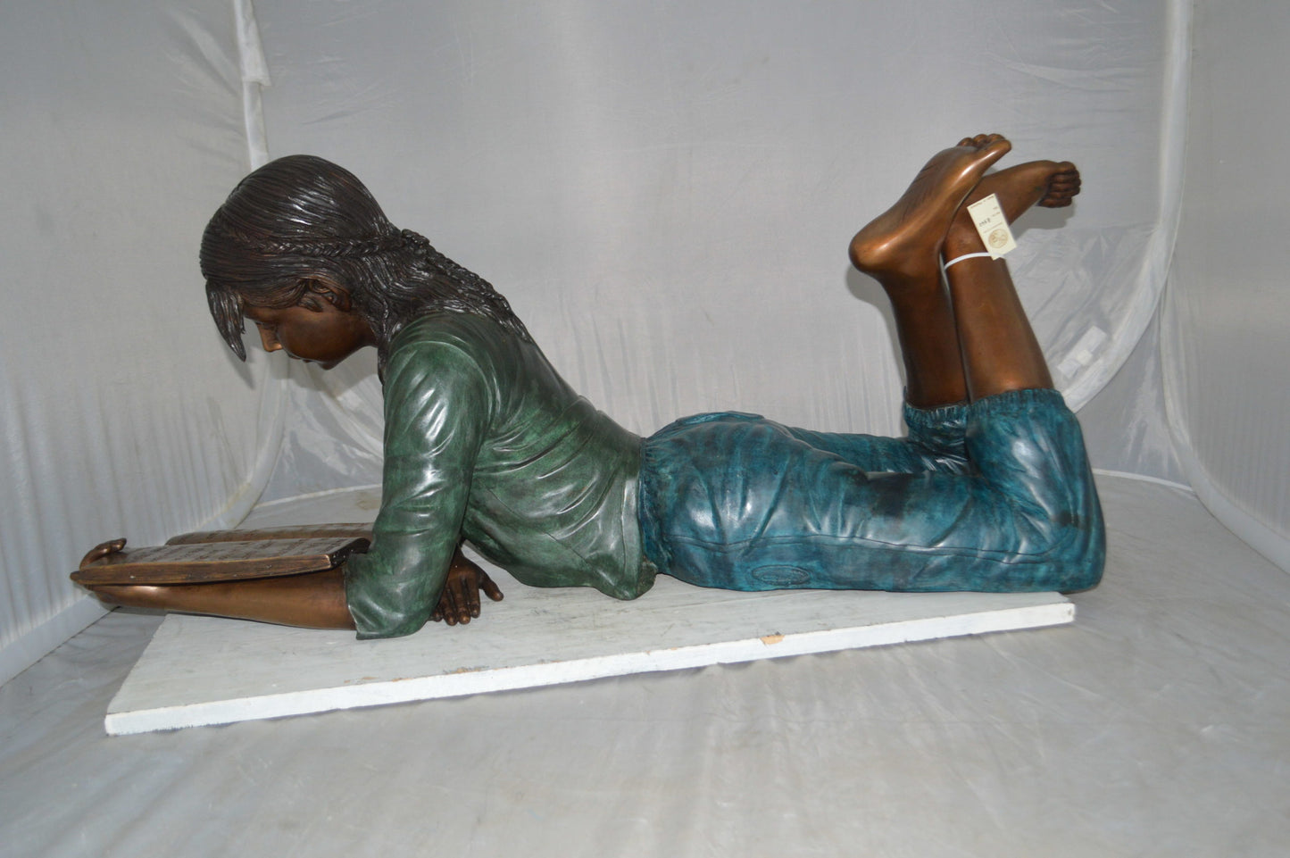 Kate Reading a Book Bronze Statue - Size: 42"L x 18"W x 17"H.