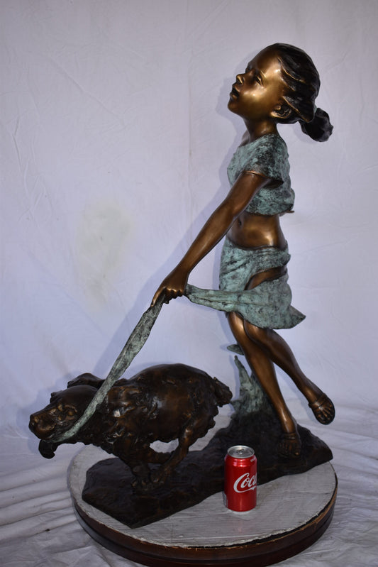 Young Girl Running with Her Dog Bronze Statue - Size: 16"L x 36"W x 39"H.