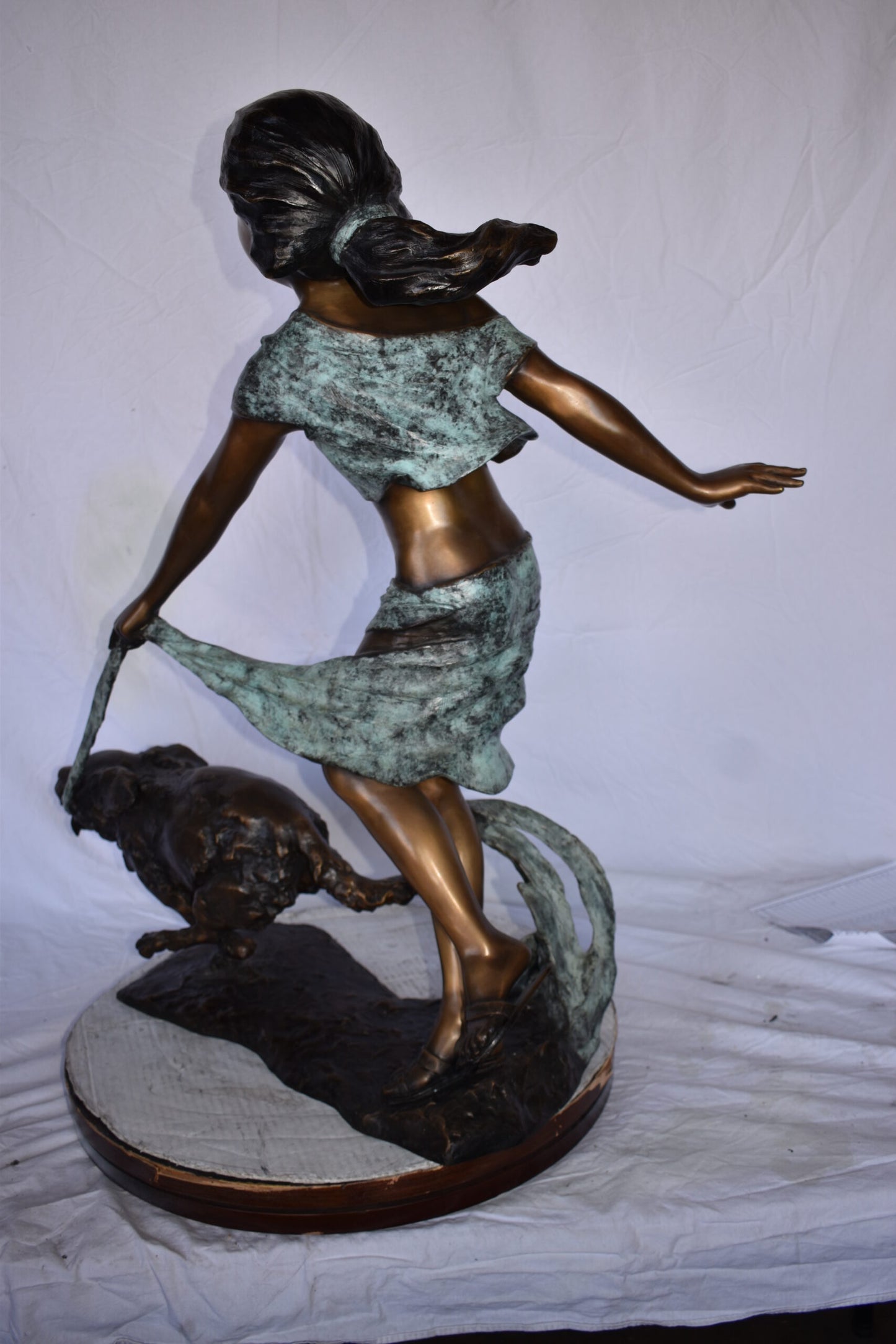 Young Girl Running with Her Dog Bronze Statue - Size: 16"L x 36"W x 39"H.