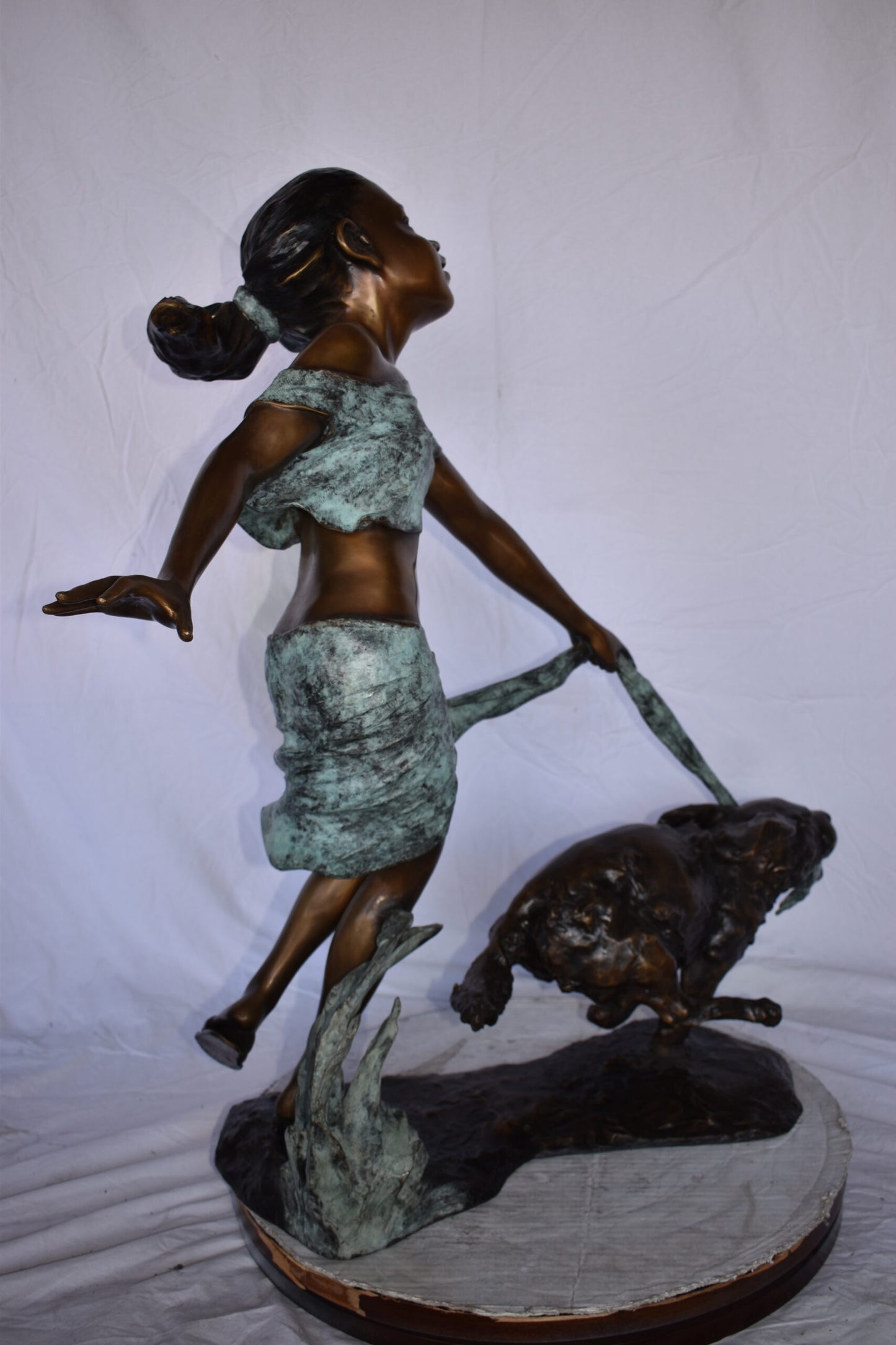 Young Girl Running with Her Dog Bronze Statue - Size: 16"L x 36"W x 39"H.