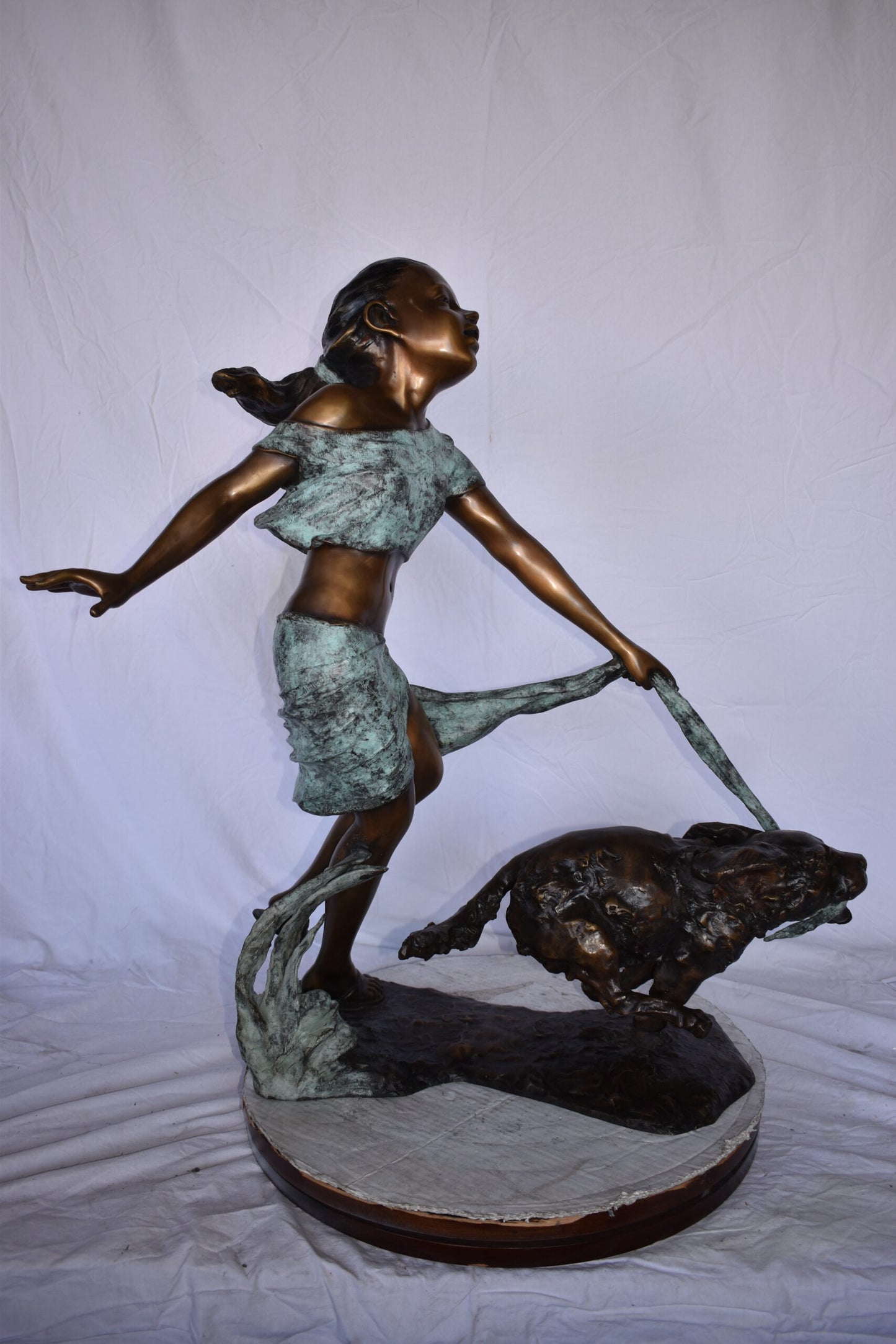 Young Girl Running with Her Dog Bronze Statue - Size: 16"L x 36"W x 39"H.