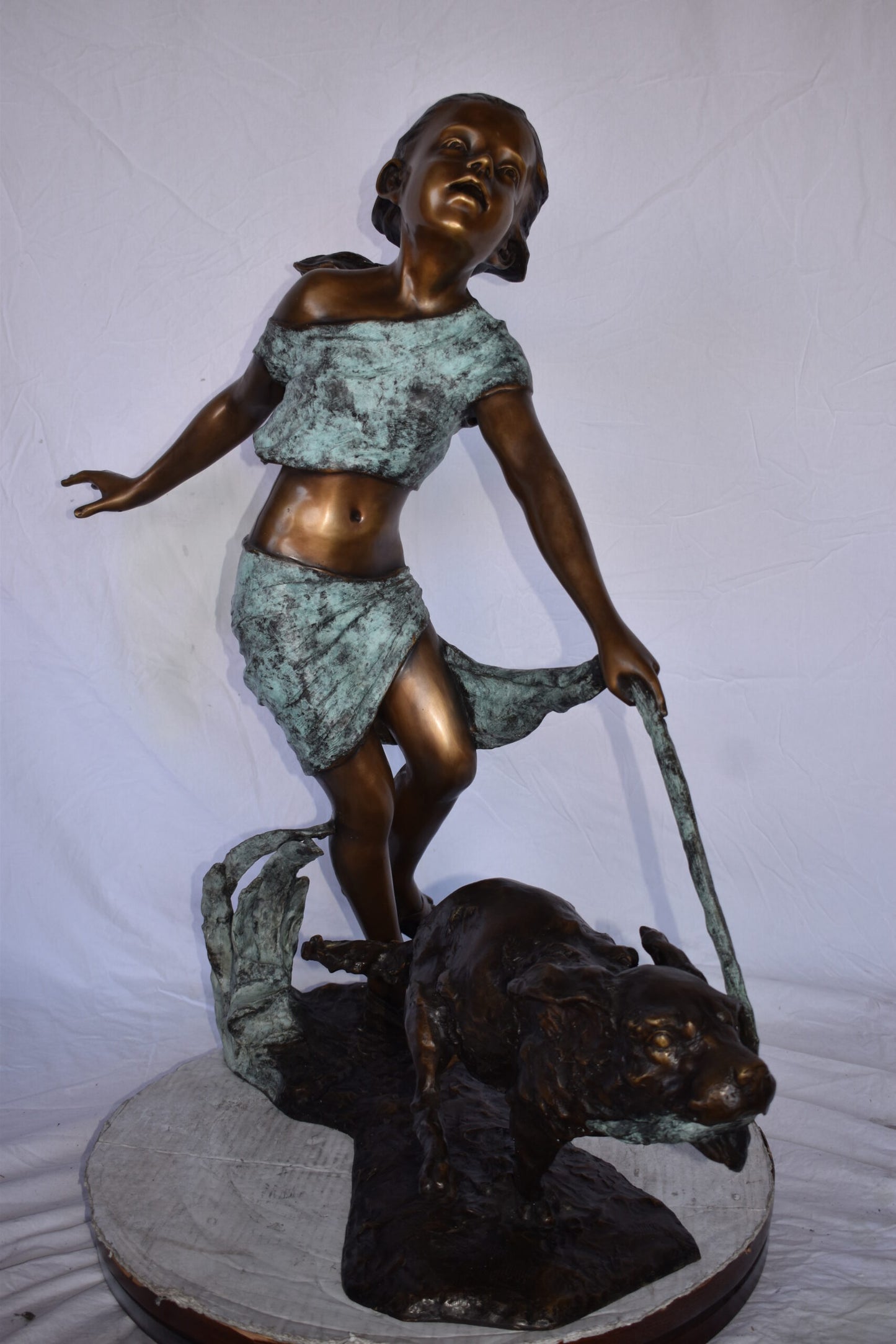 Young Girl Running with Her Dog Bronze Statue - Size: 16"L x 36"W x 39"H.