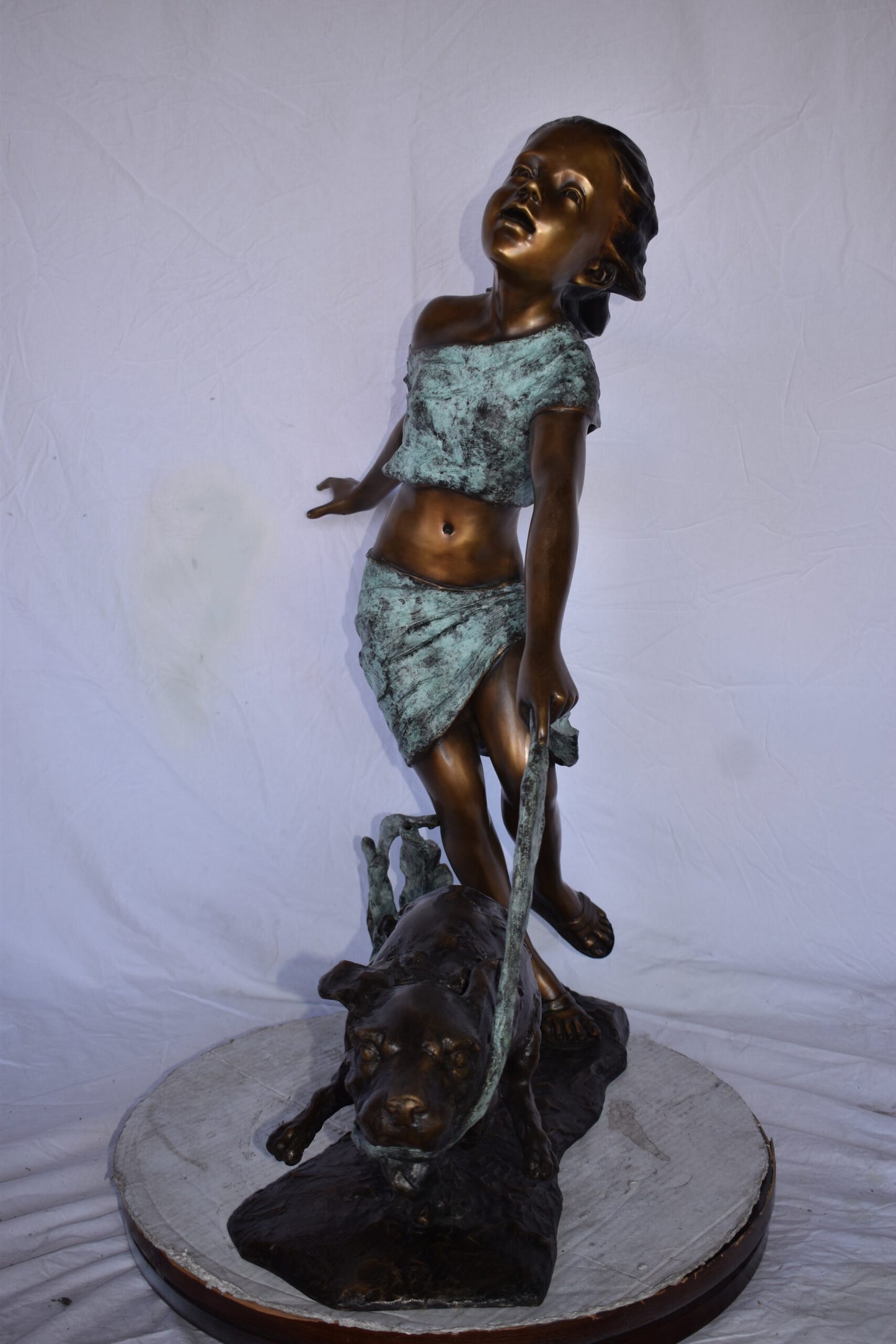 Young Girl Running with Her Dog Bronze Statue - Size: 16"L x 36"W x 39"H.