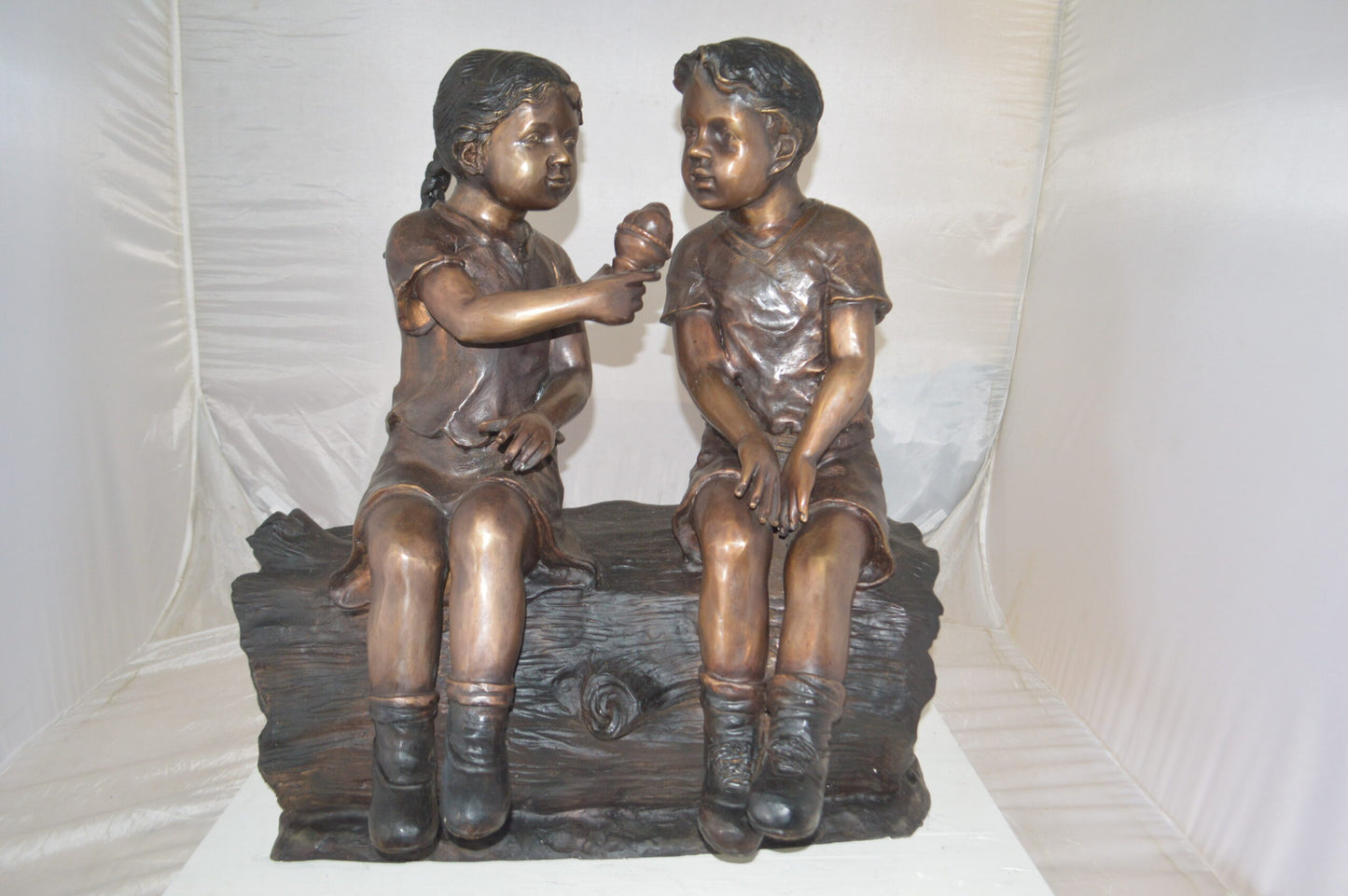 Boy and Girl enjoying an ice-cream bronze statue -  Size: 28"L x 24"W x 33"H.