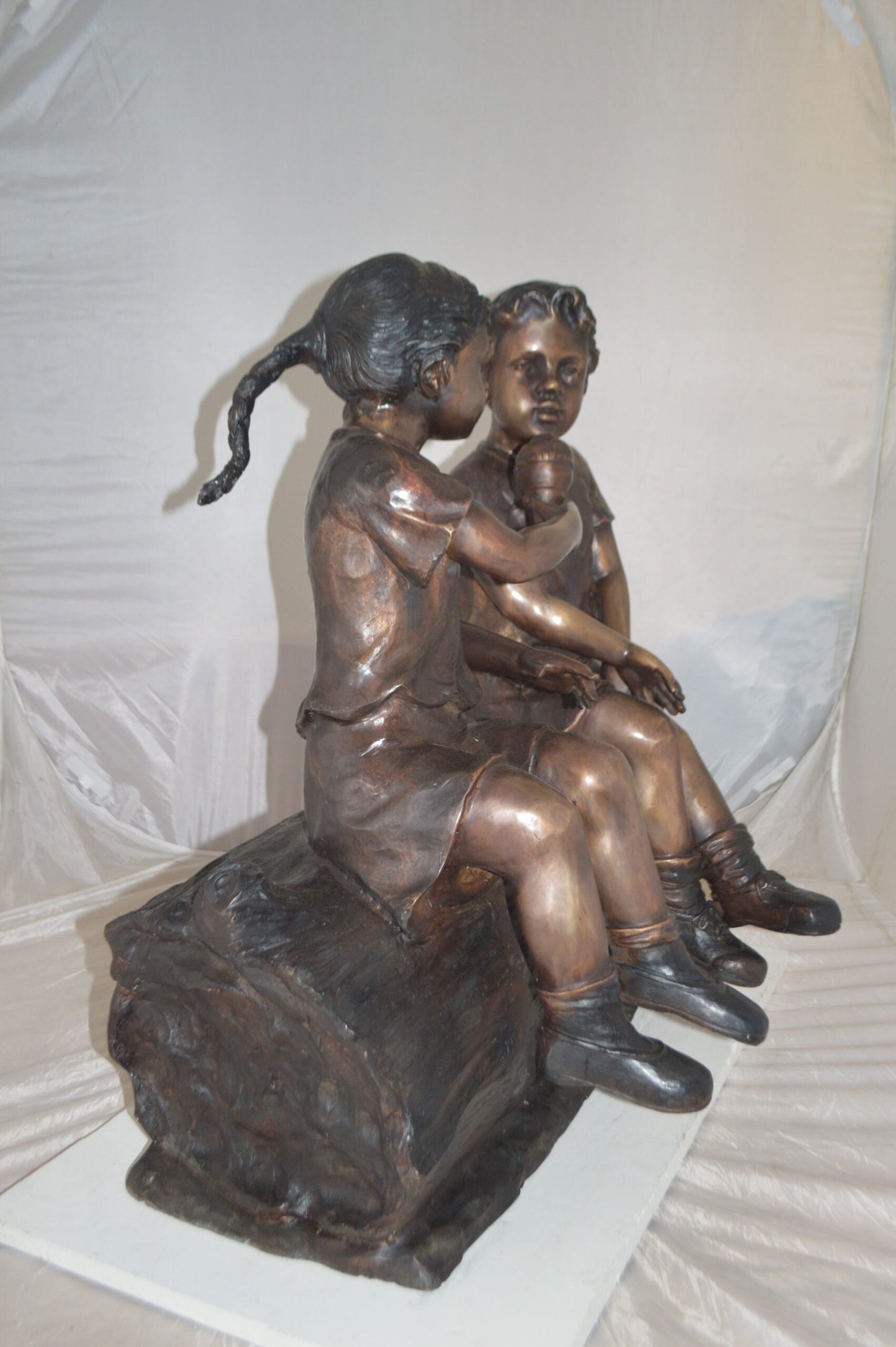 Boy and Girl enjoying an ice-cream bronze statue - Size: 28"L x 24"W x 33"H.