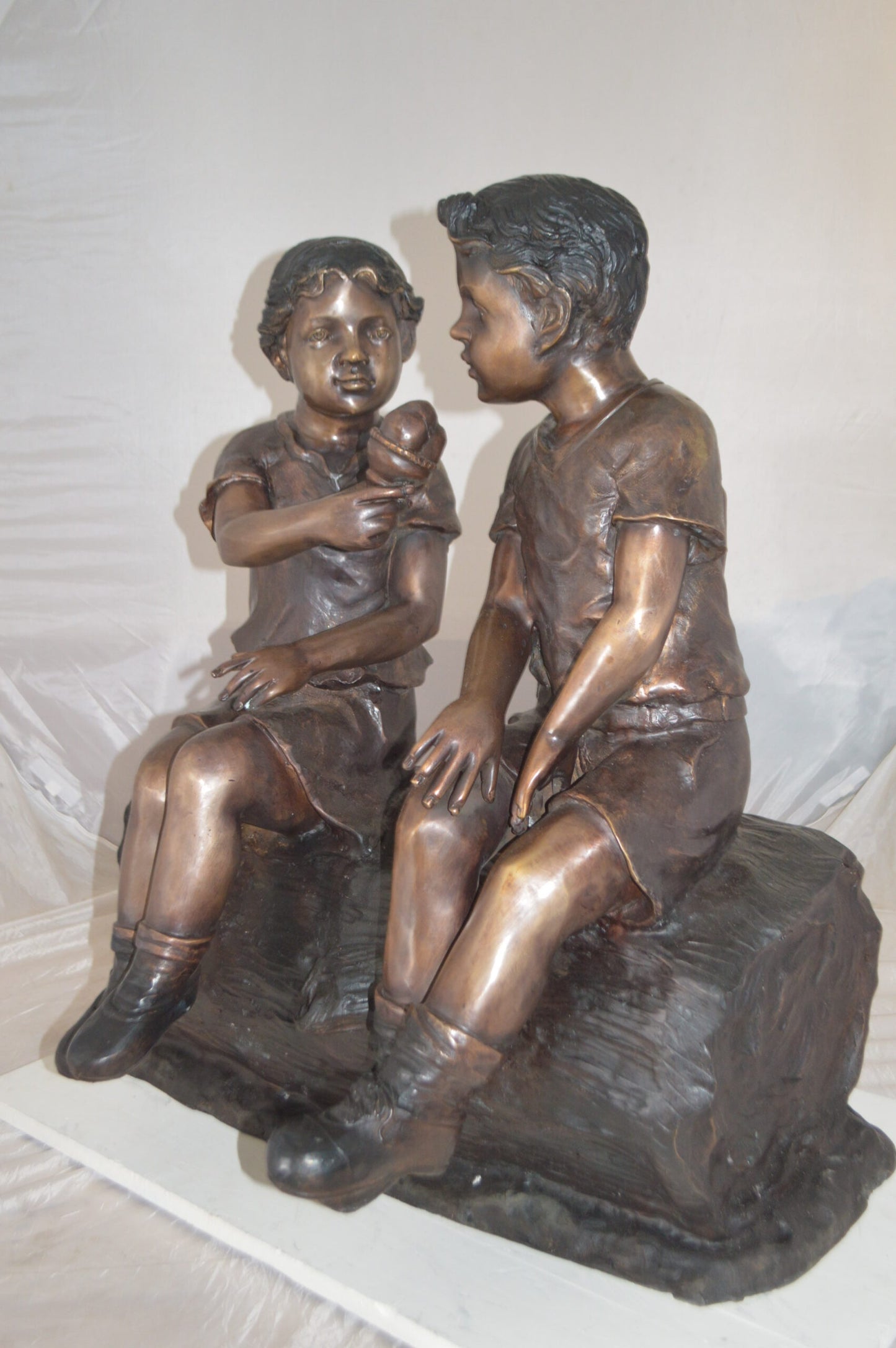 Boy and Girl enjoying an ice-cream bronze statue - Size: 28"L x 24"W x 33"H.