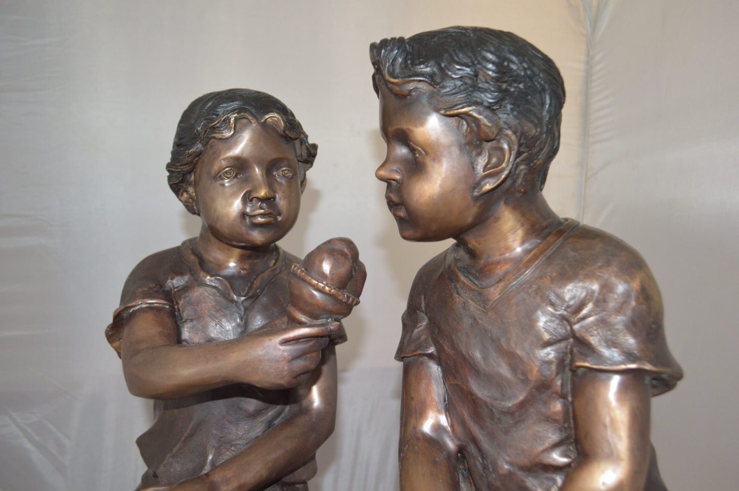 Boy and Girl enjoying an ice-cream bronze statue - Size: 28"L x 24"W x 33"H.