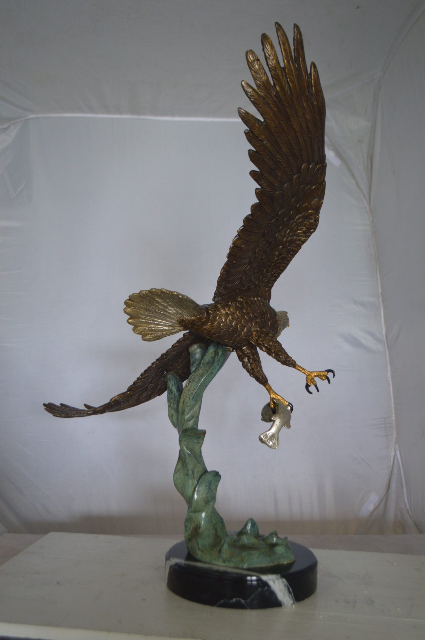 Eagle Flying With His Pray Bronze Statue - Size: 32"L x 15"W x 33"H.