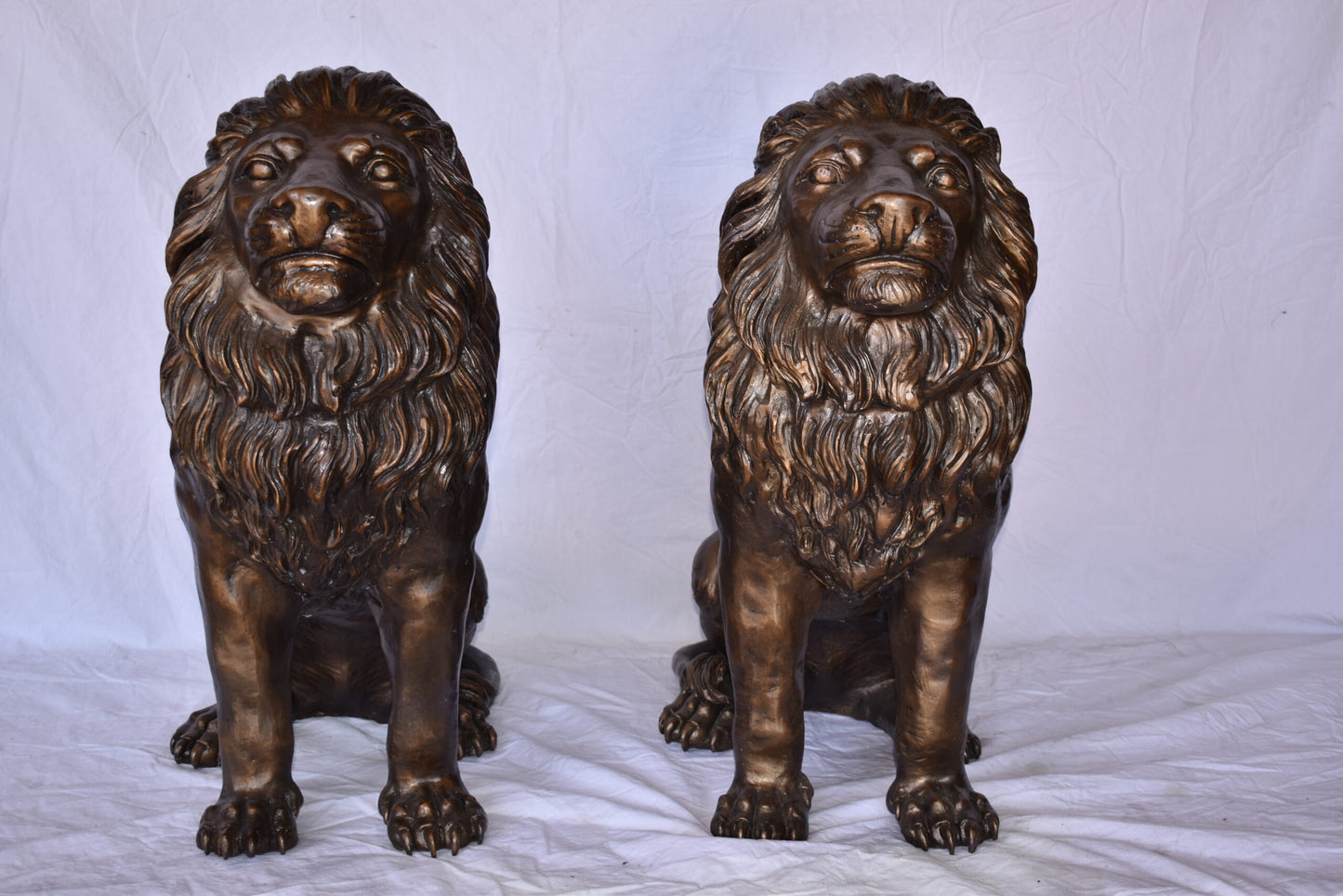 A Pair of Lions Sitting on The Ground Bronze Statues Size: 14" x 27" x 29"H