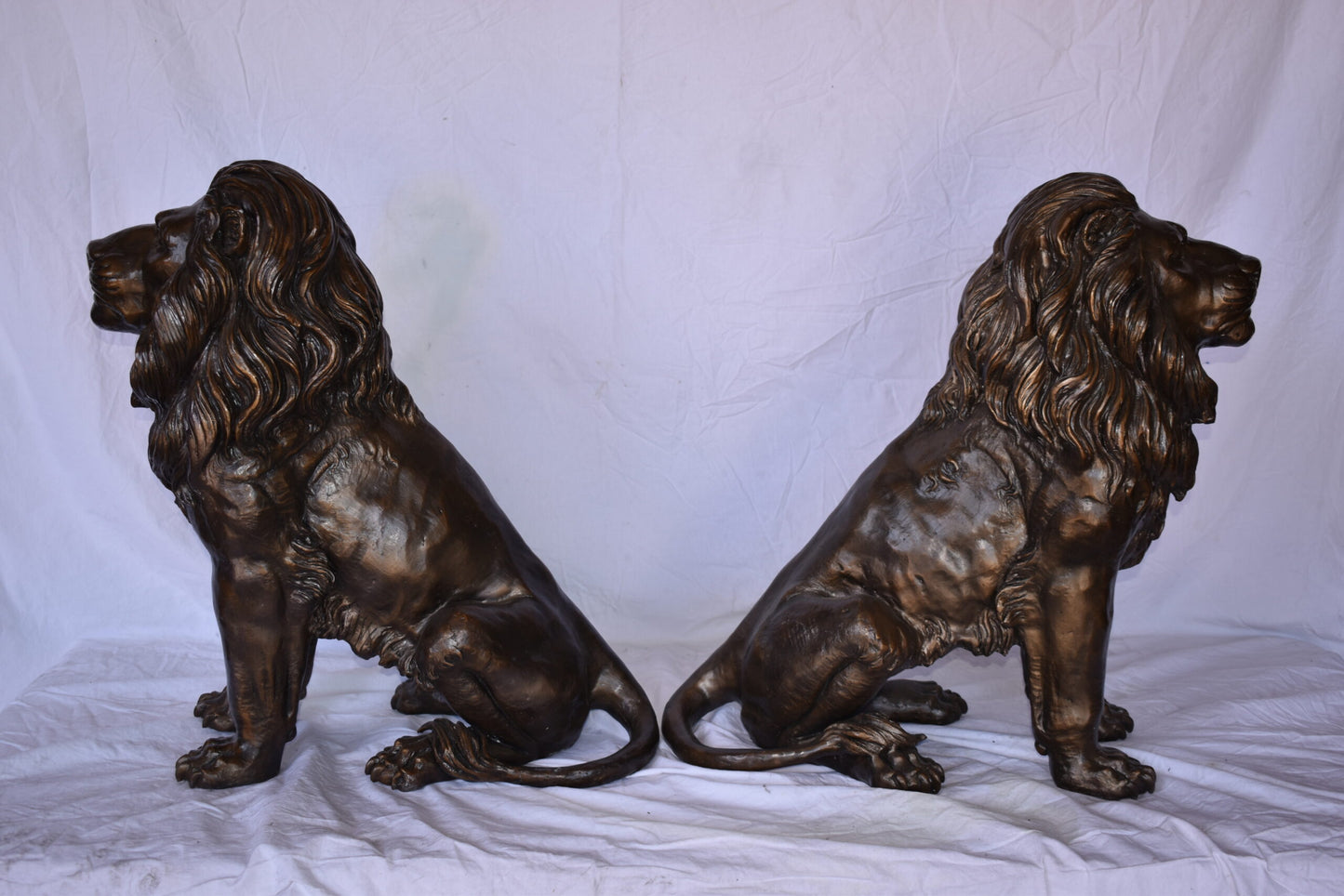 A Pair of Lions Sitting on The Ground Bronze Statues Size: 14" x 27" x 29"H