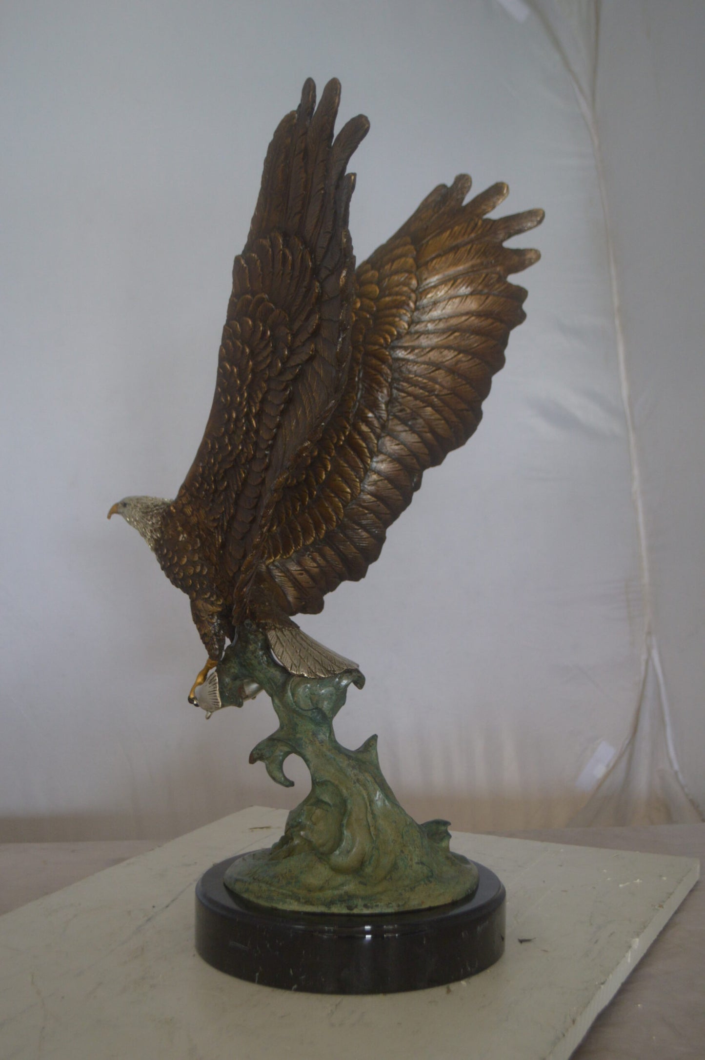 Eagle Catching His Prey from Water Bronze Statue -  Size: 14"L x 13"W x 26"H.