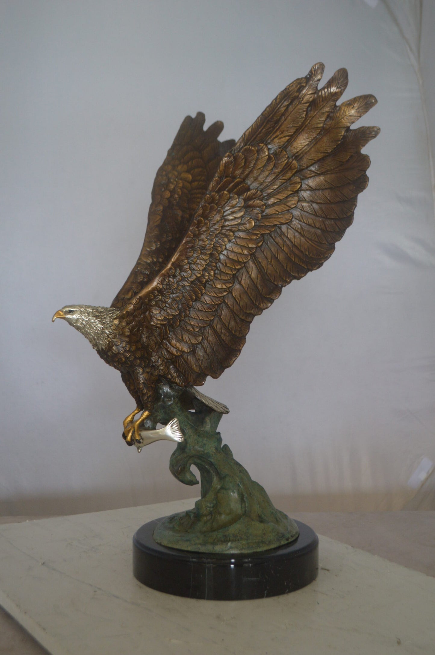 Eagle Catching His Prey from Water Bronze Statue -  Size: 14"L x 13"W x 26"H.