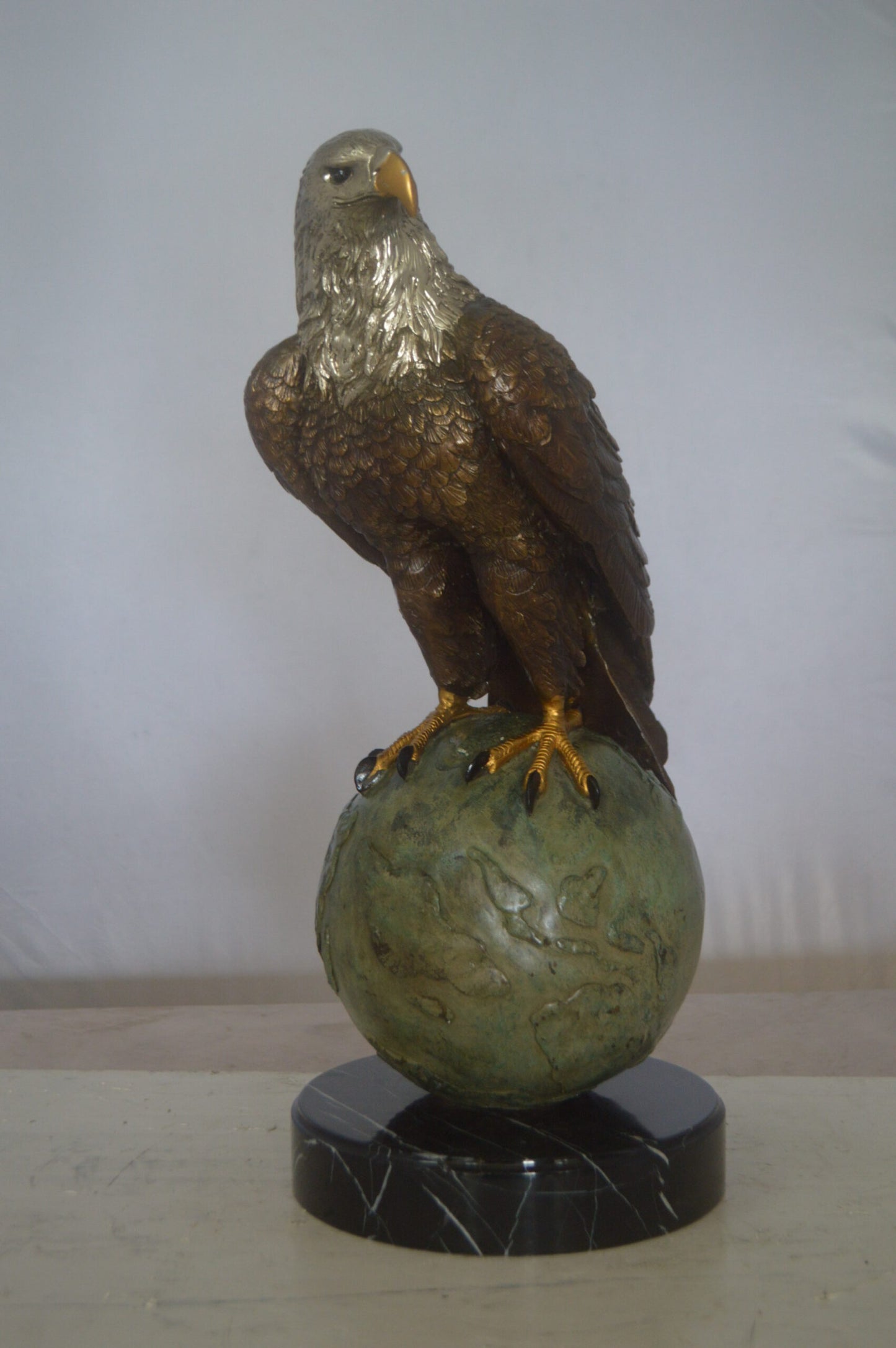 Bald Eagle Standing on a Globe Bronze Statue - Size: 17"L x 9"W x 23"H.