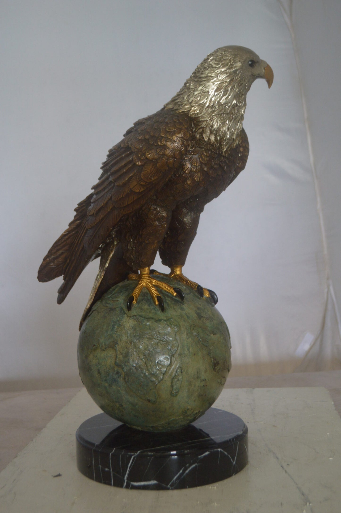 Bald Eagle Standing on a Globe Bronze Statue - Size: 17"L x 9"W x 23"H.