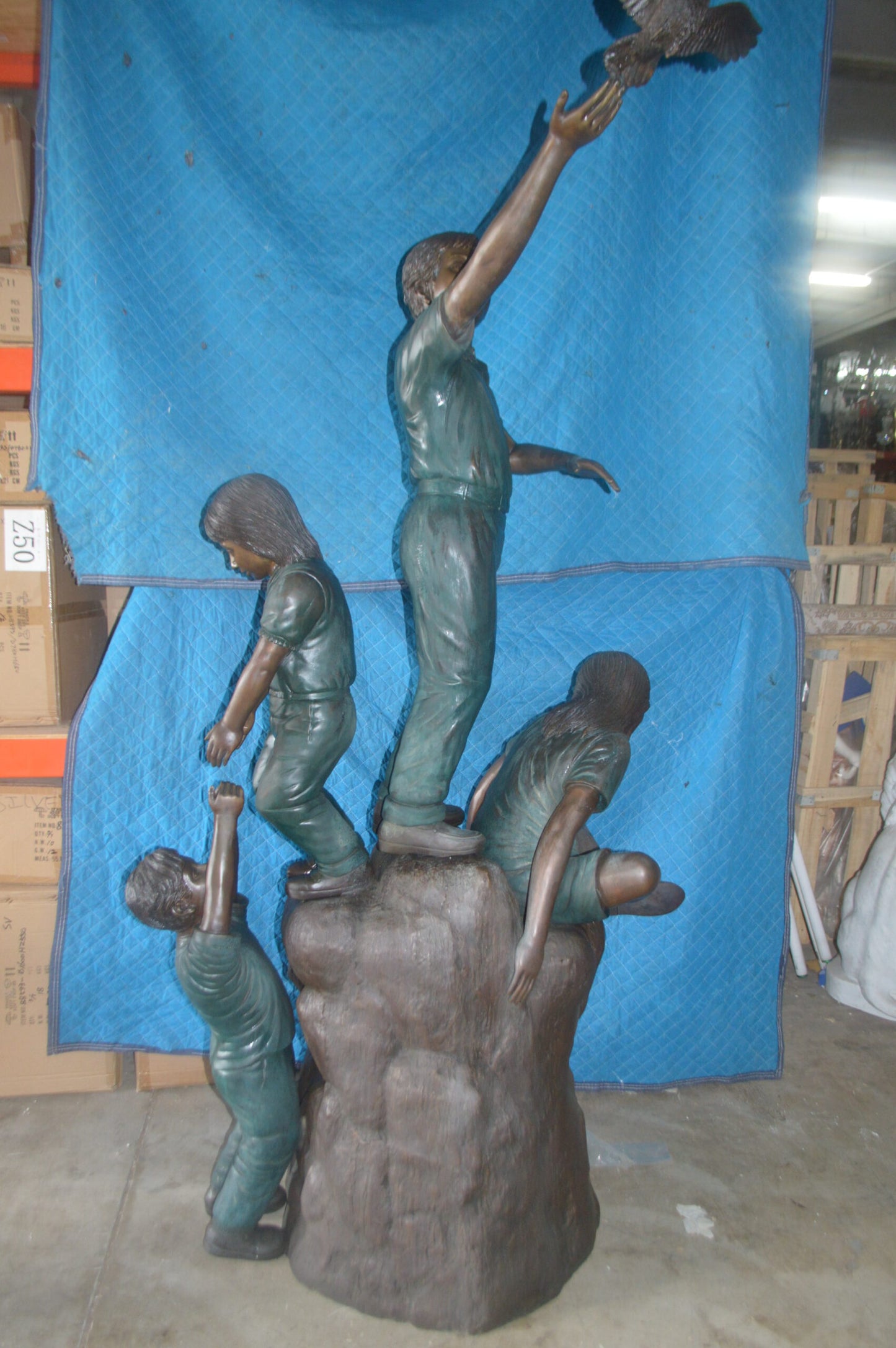 Four Kids Playing on a Rock Bronze Statue -  Size: 49"L x 26"W x 89"H.